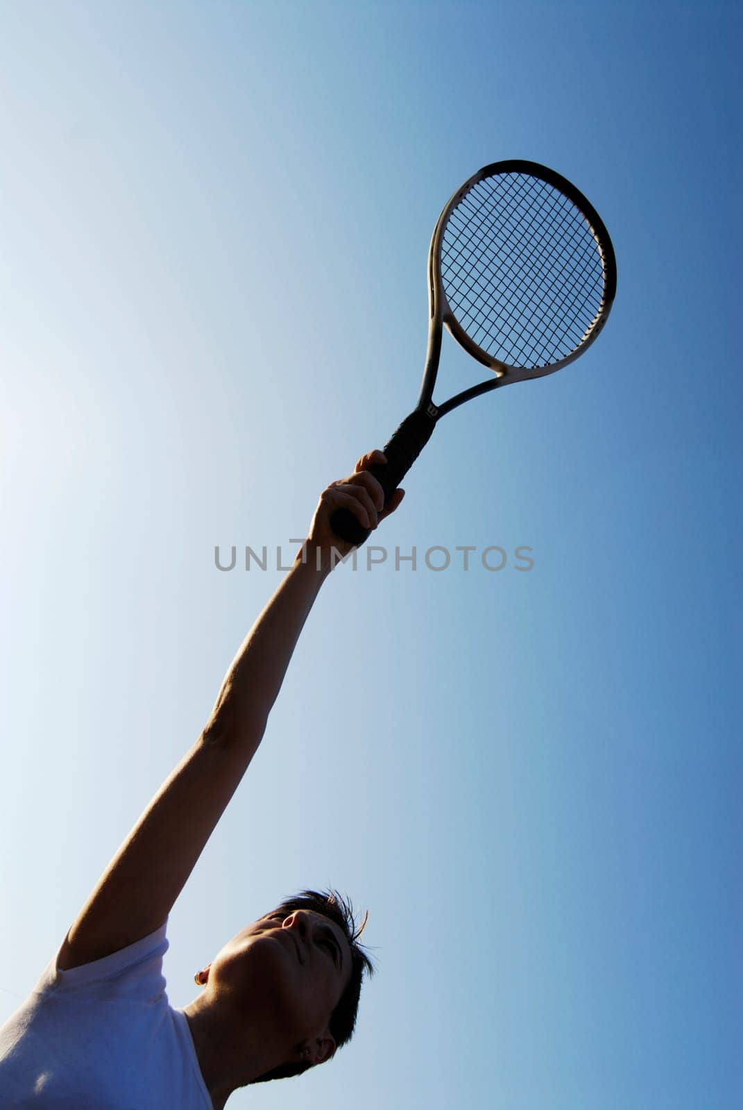 Low angle view of a mid adult woman holding a tennis racket