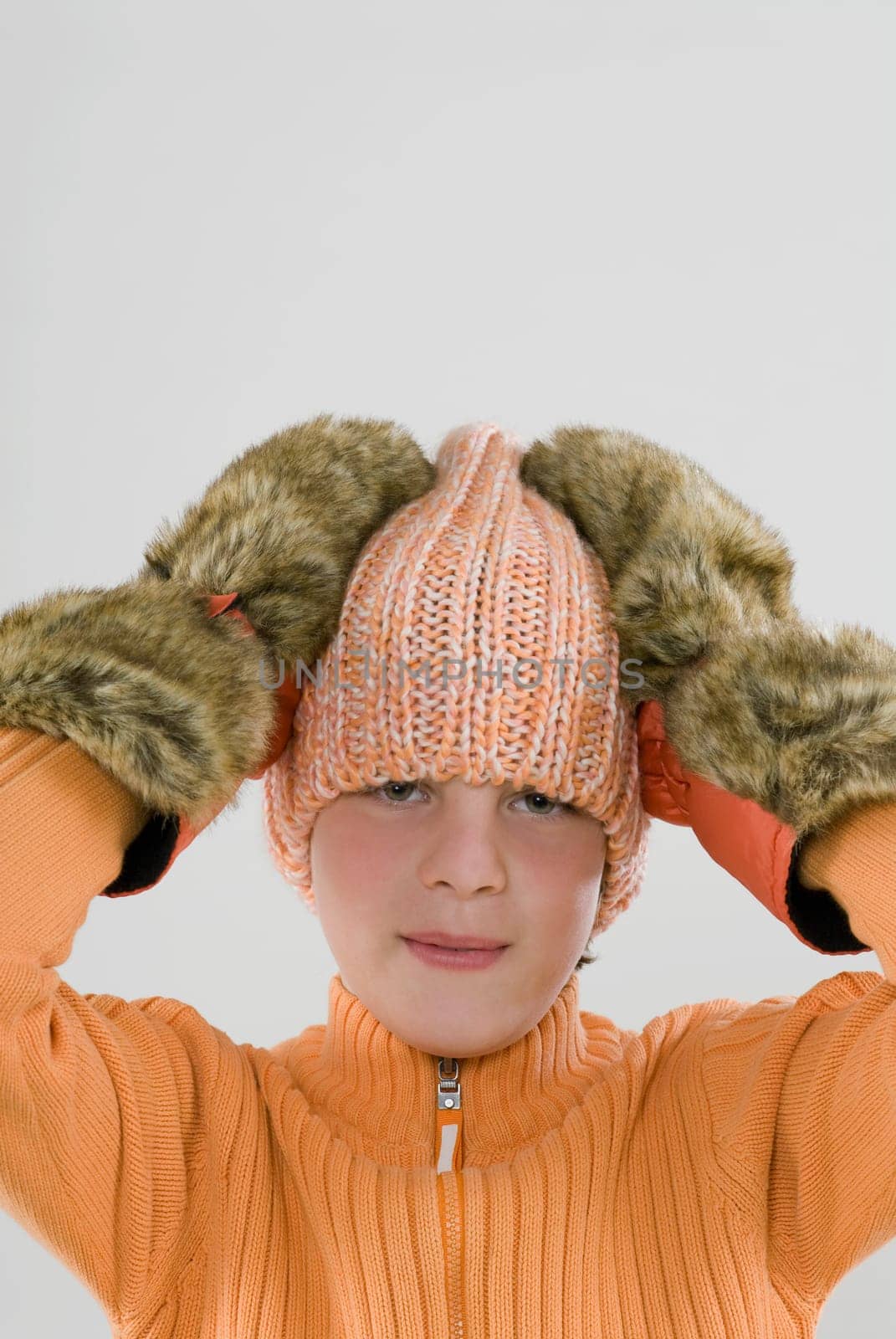 Portrait of a boy with his hands on his head
