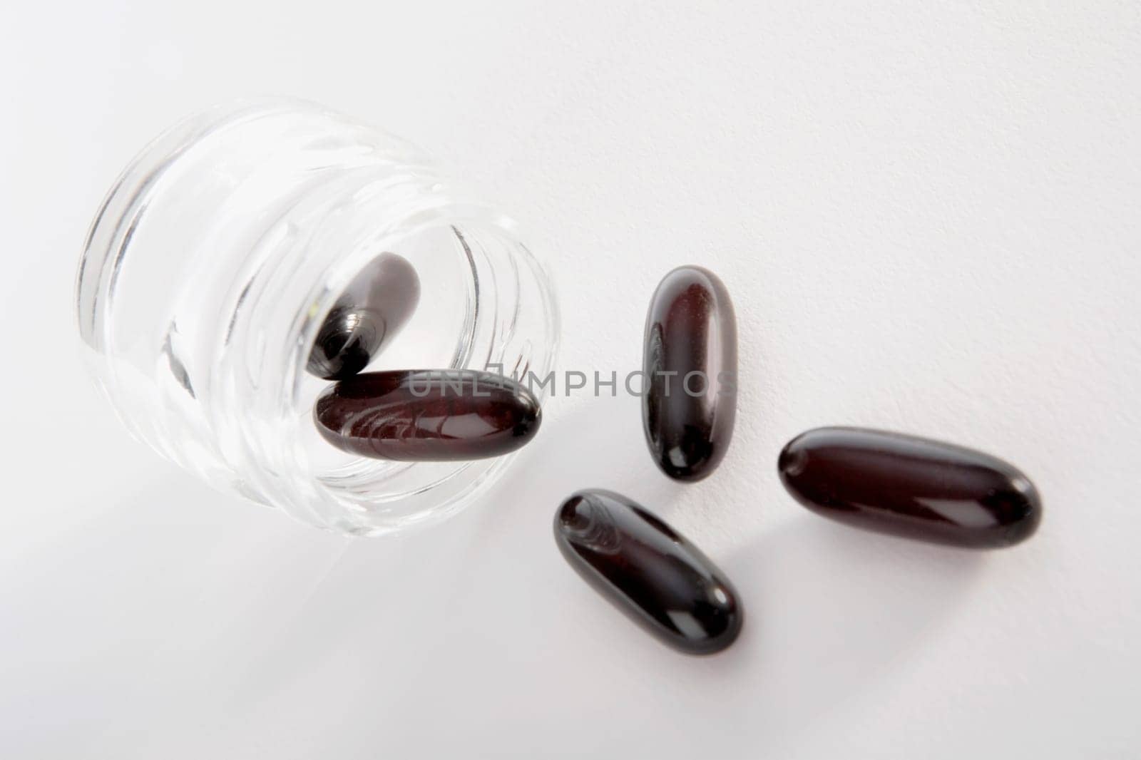 Close-up of capsules spilling from a pill bottle