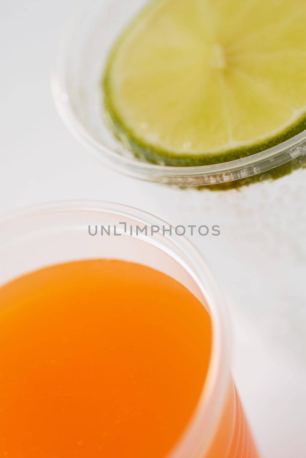 Close-up of a glass of orange juice and a glass of lemonade