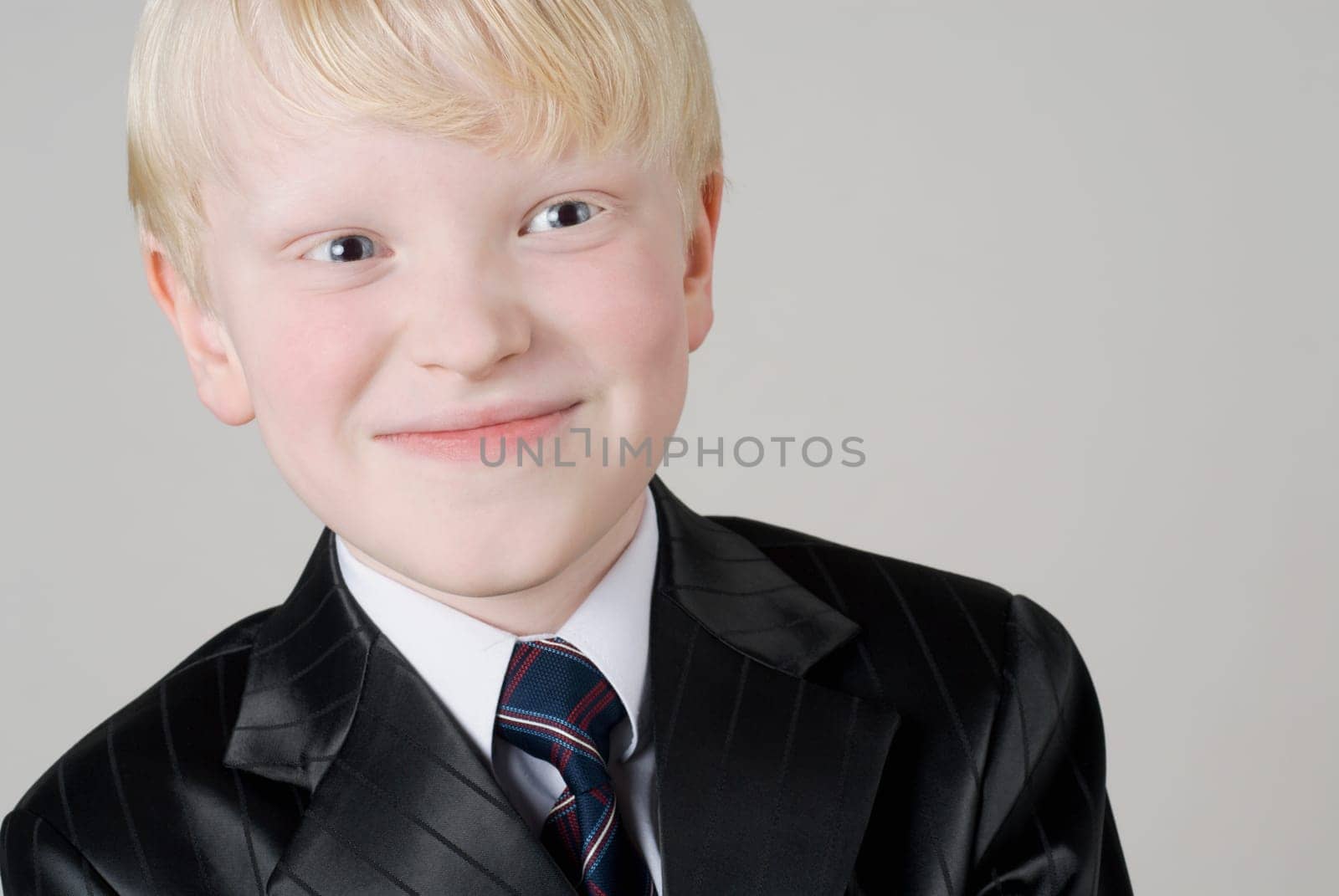 Close_up of a boy smirking