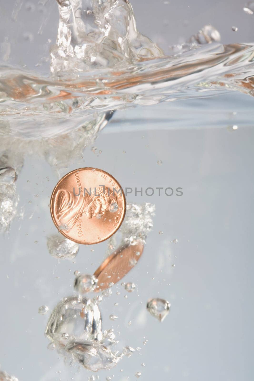 Close_up of two coins in water