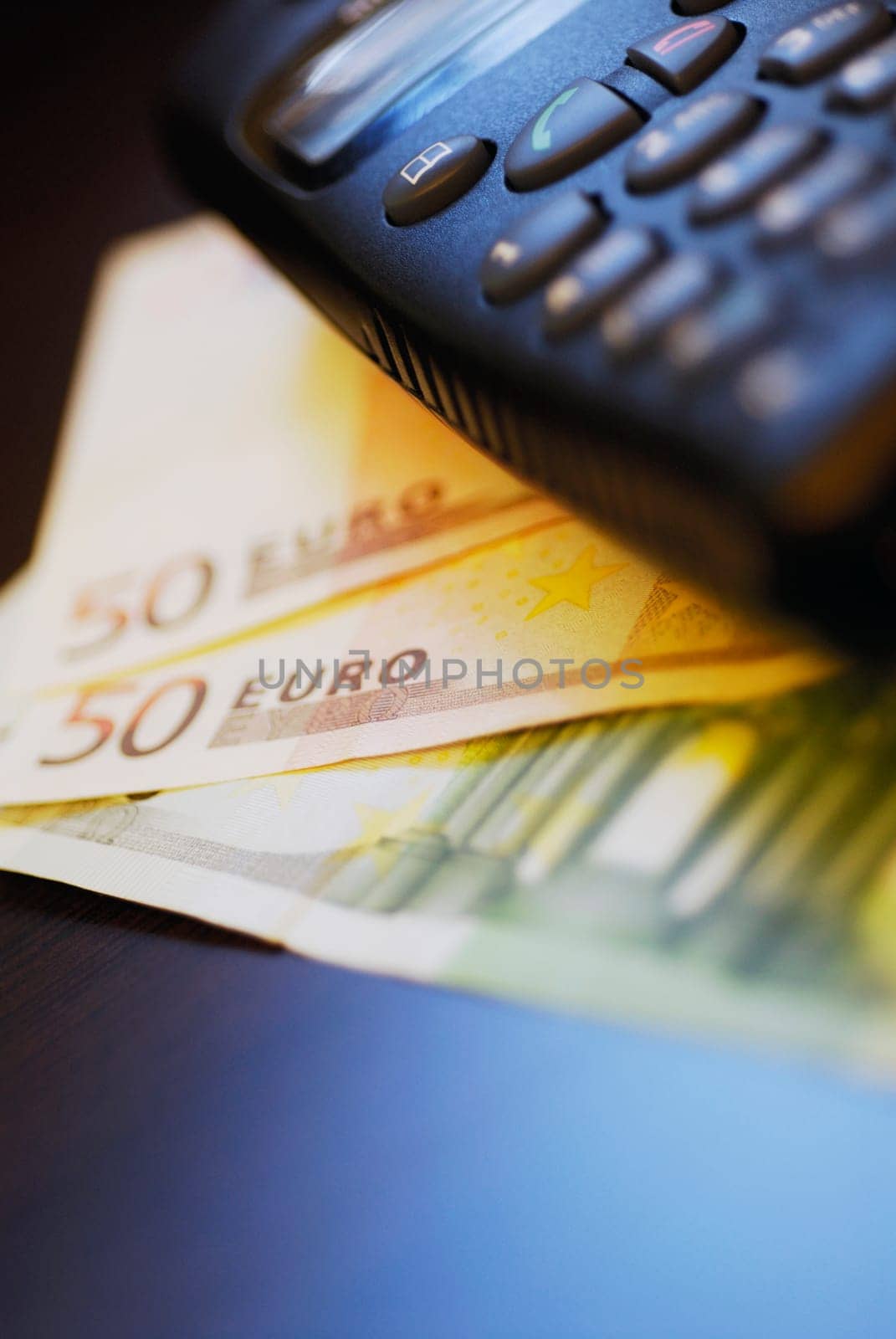 Close-up of a mobile phone on fifty Euro banknotes