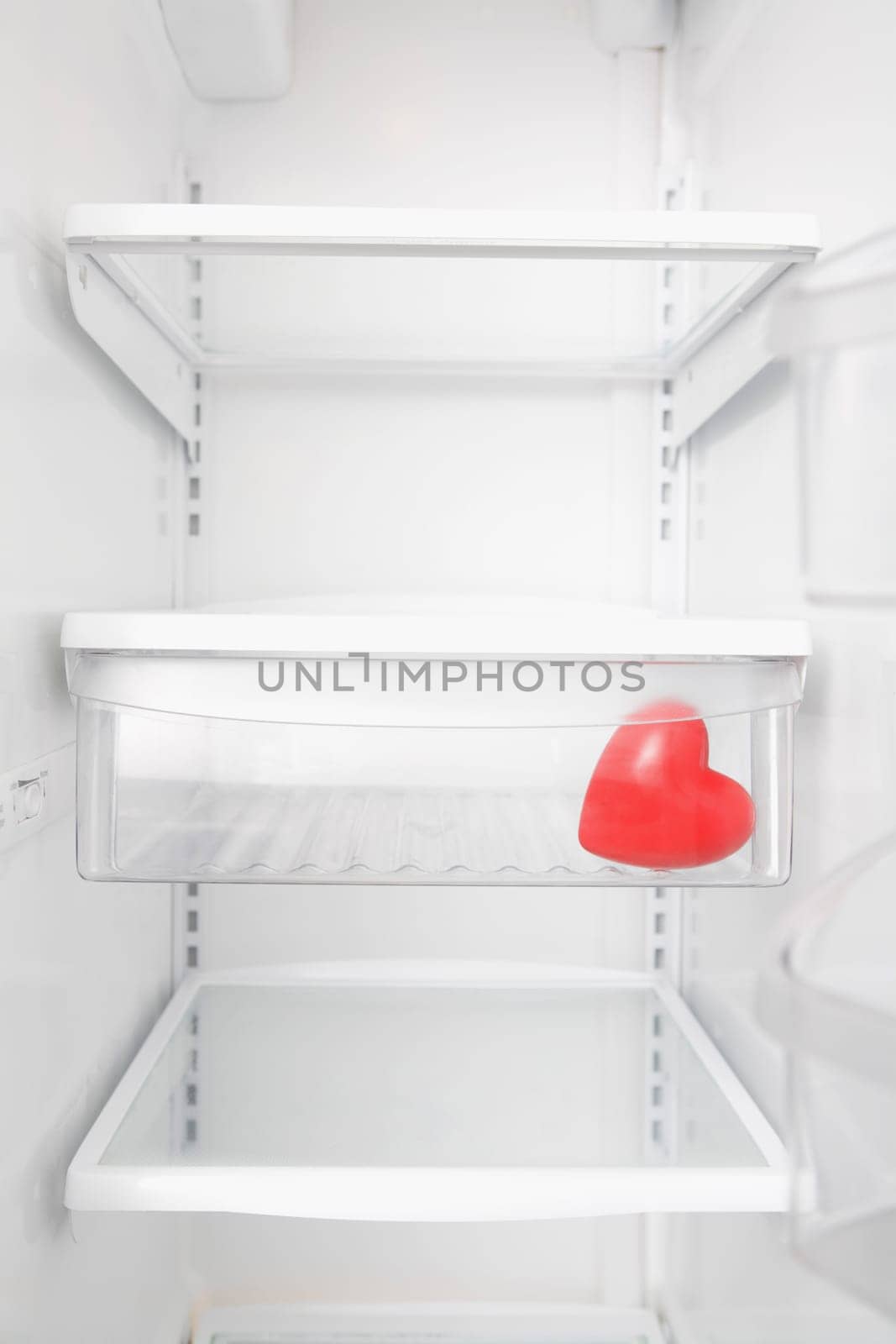 Heart shaped balloon in a refrigerator
