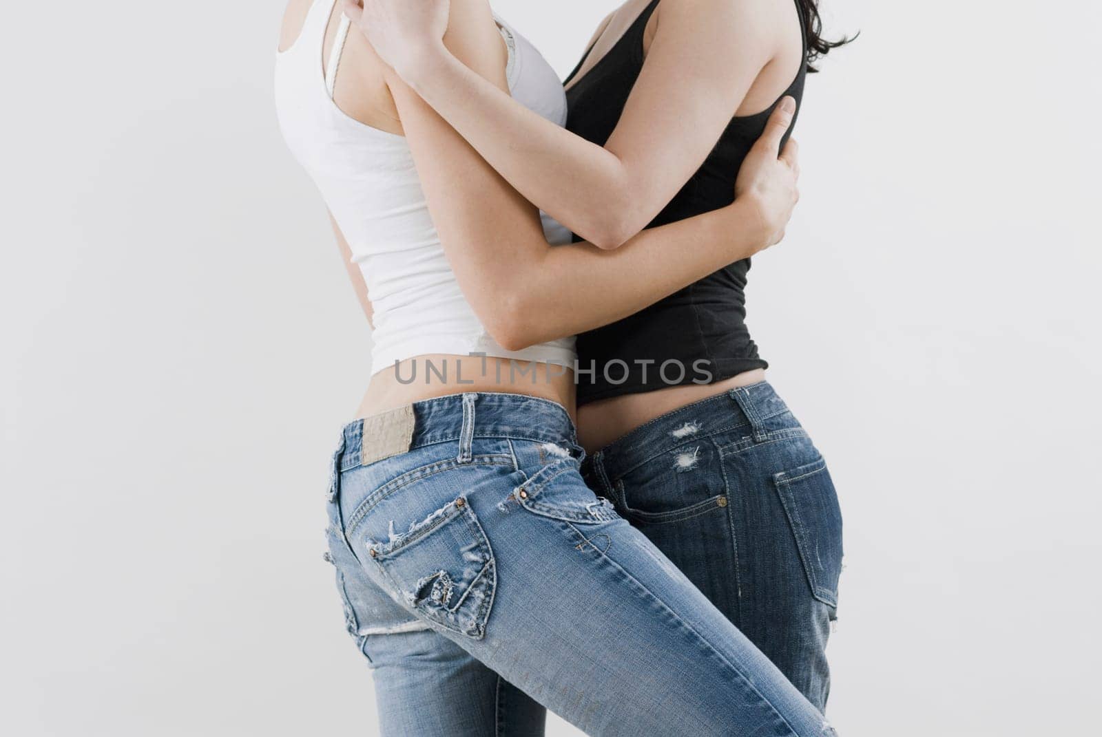 Mid section view of a female homosexual couple embracing each other