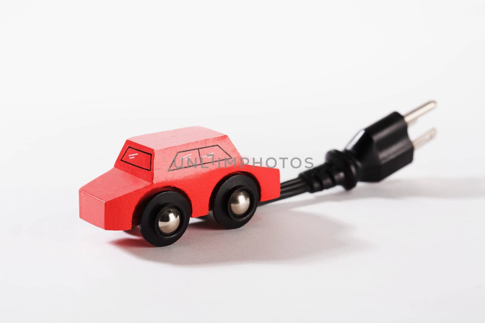 Close_up of a toy electric car with an electric plug
