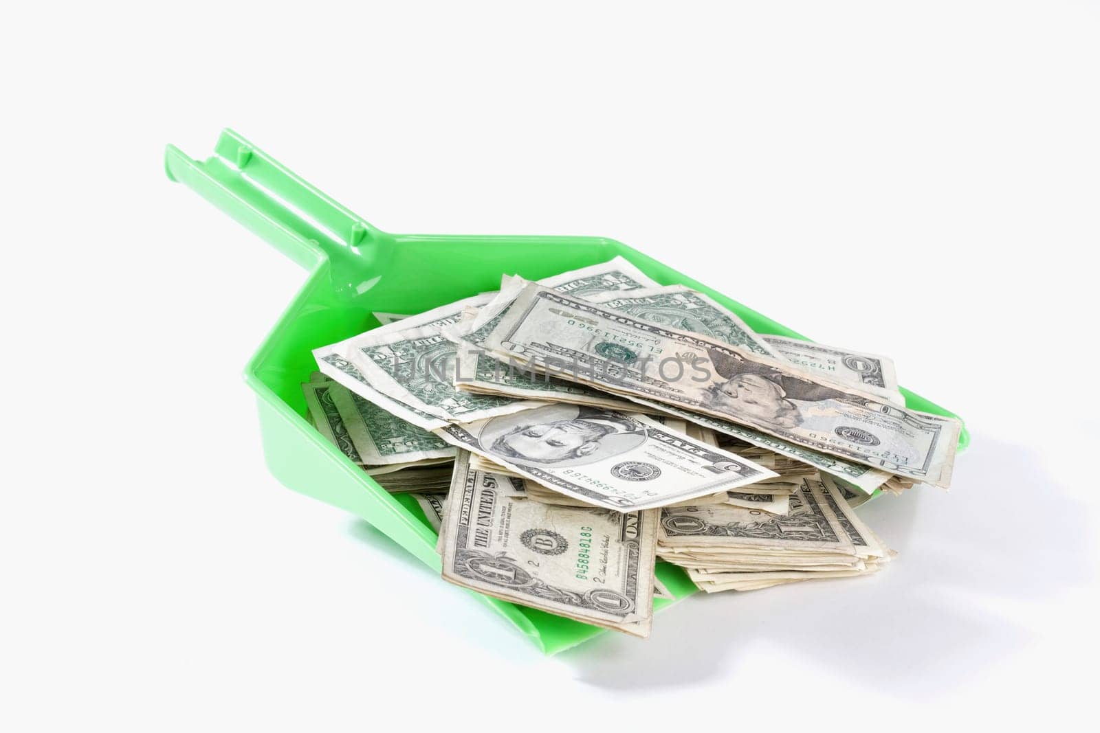 Close_up of US dollar bills in a dustpan