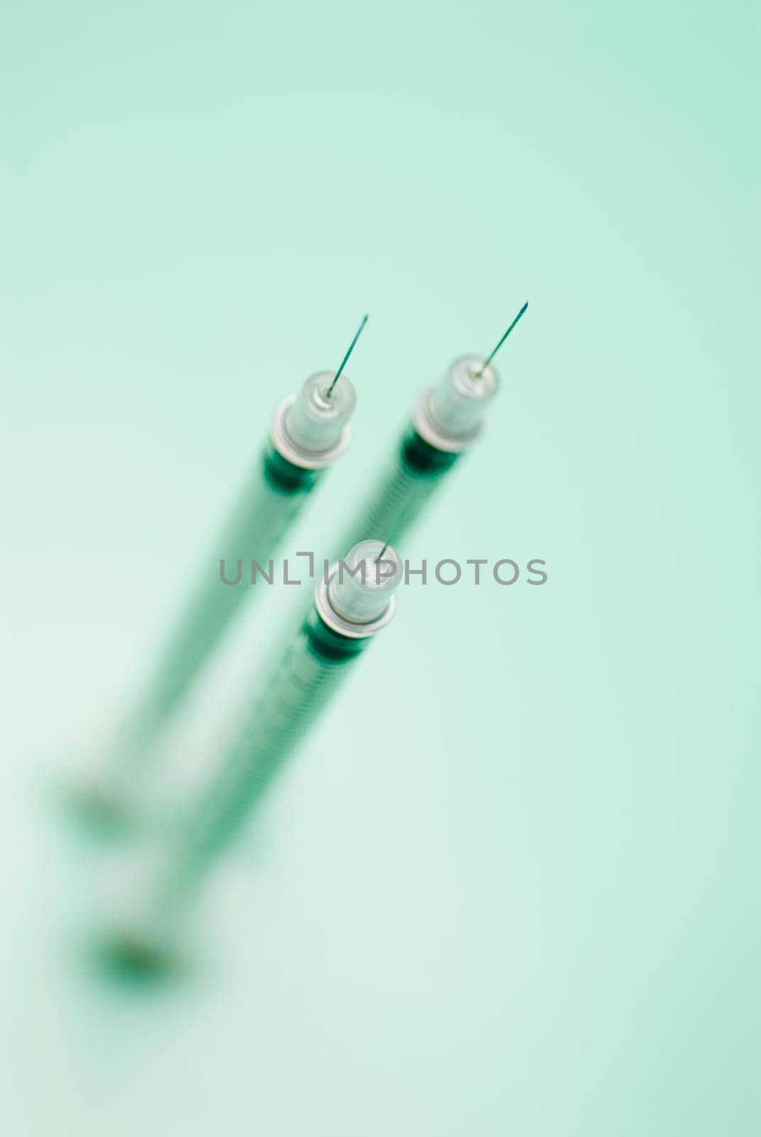 High angle view of three syringes