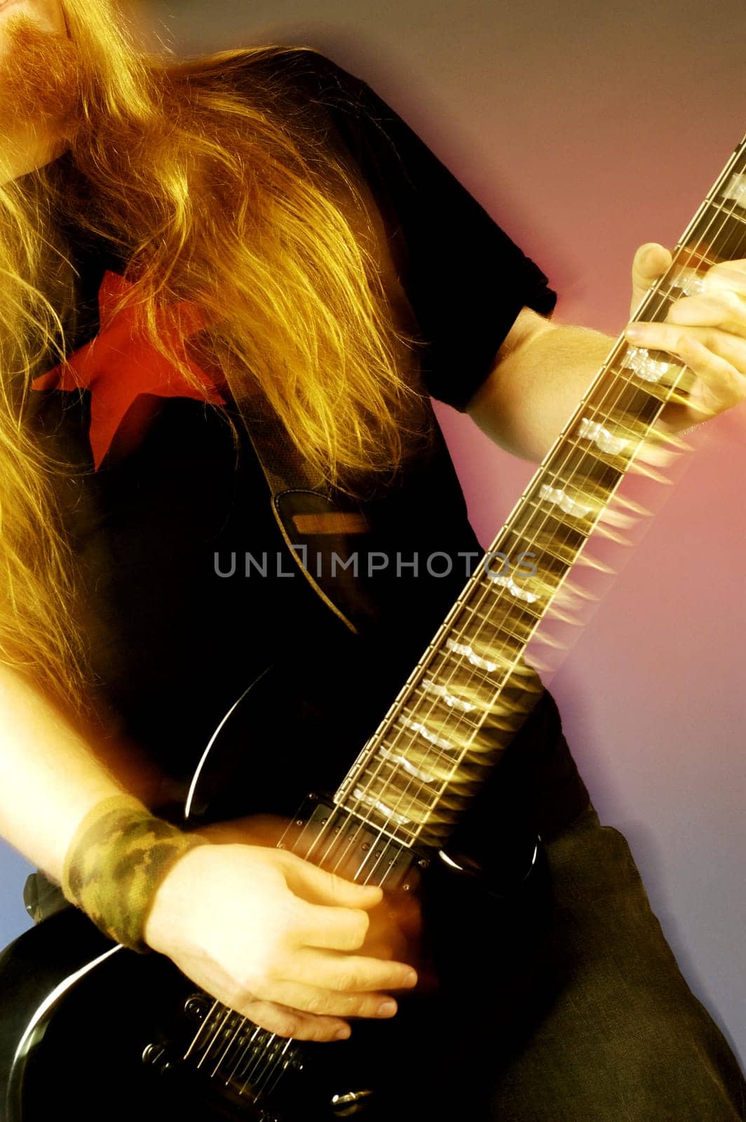 Mid section view of a musician playing the electric guitar