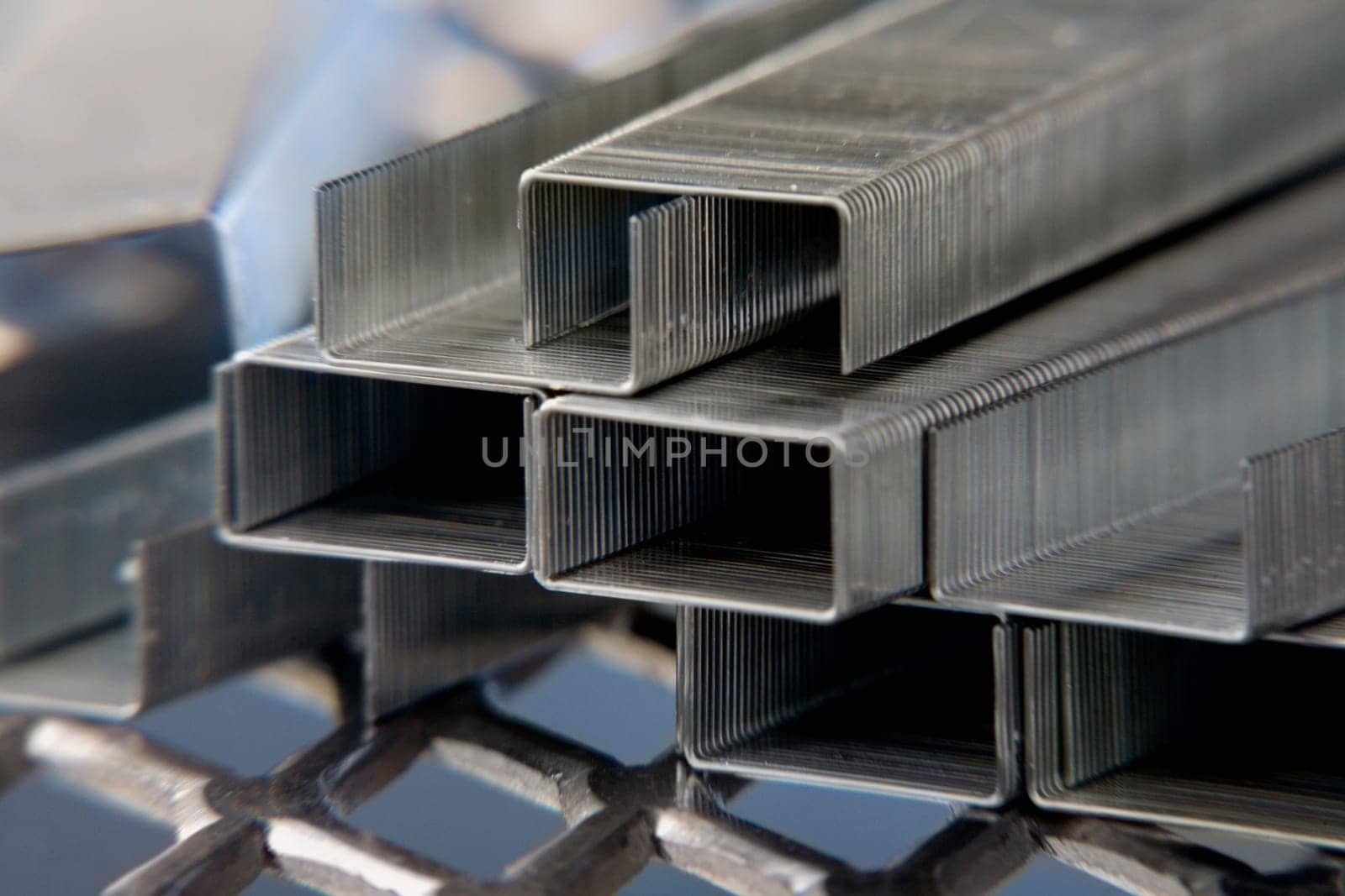 Close-up of a stack of staples on a metal grill
