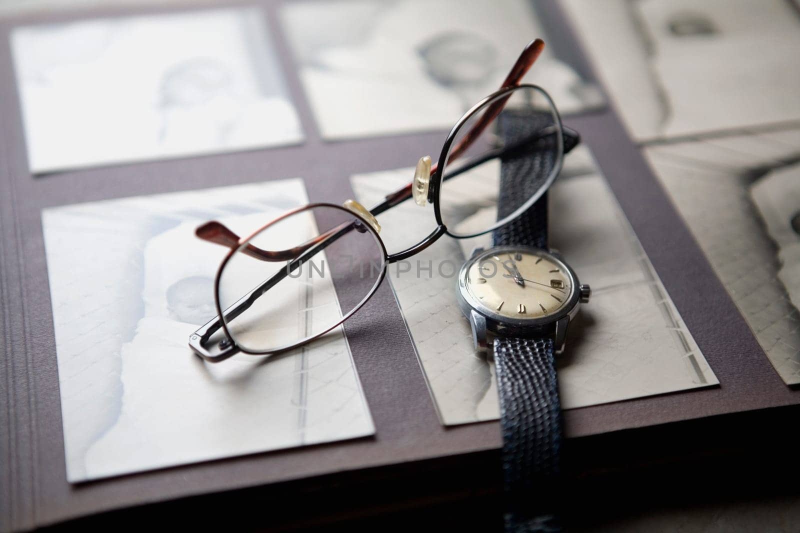 Close-up of a wristwatch and a pair of eyeglasses