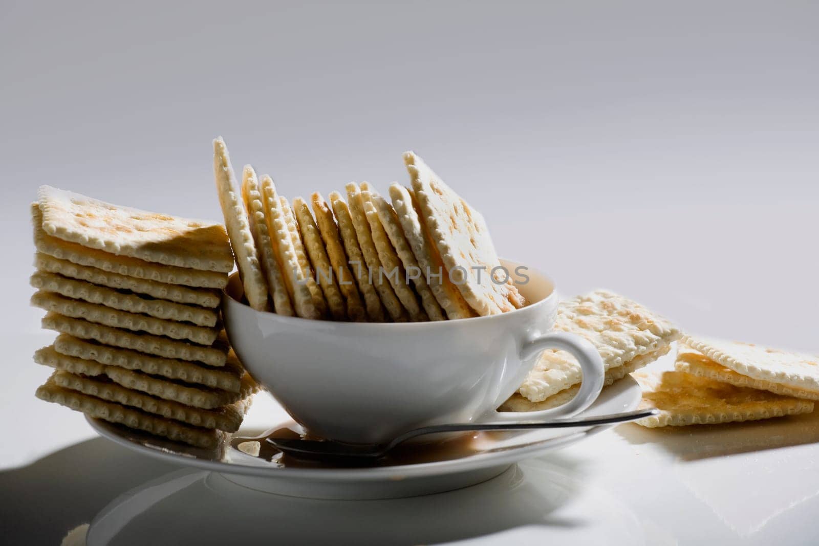Close-up of crackers in a plate with a cup of tea