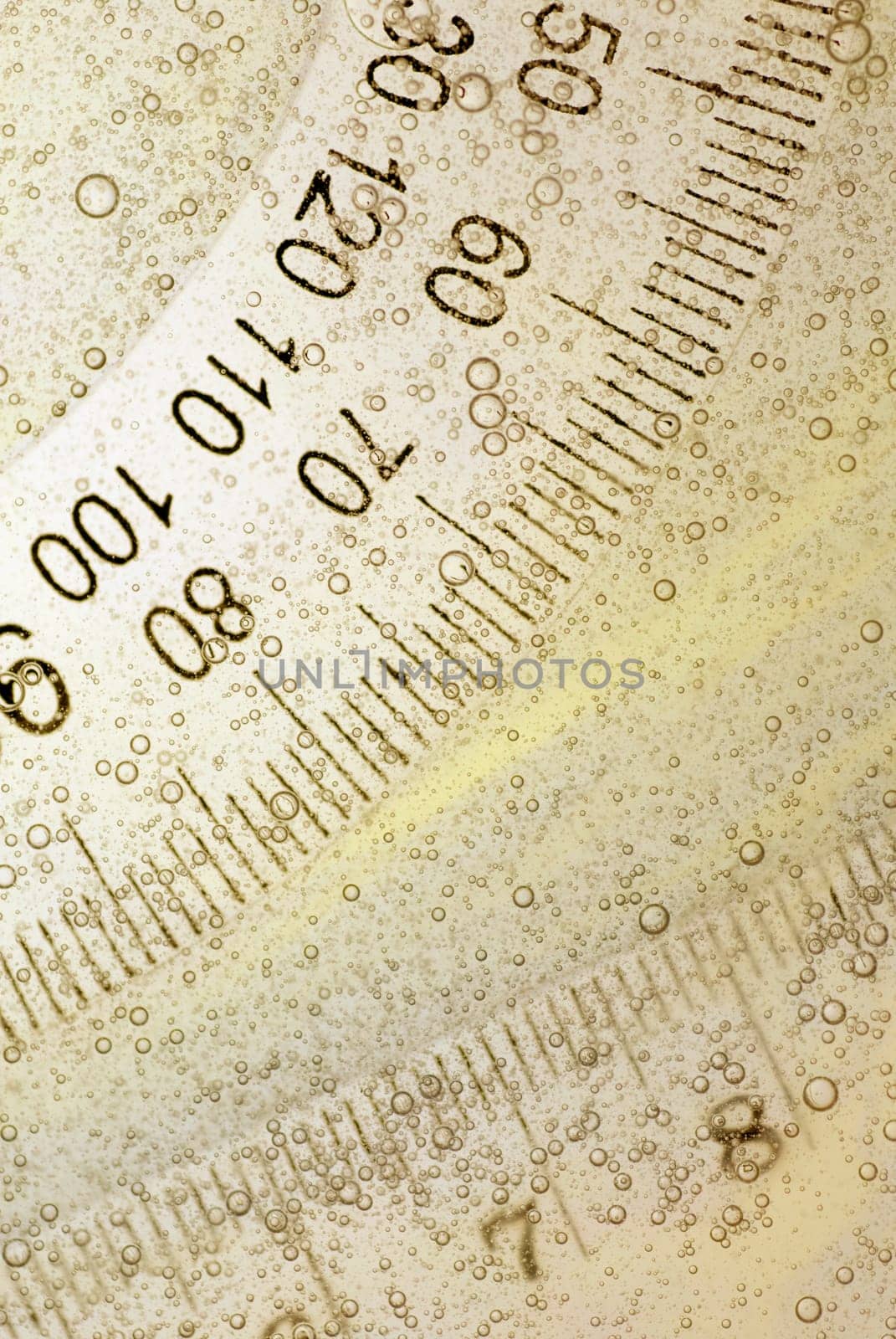 Close-up of a protractor and a ruler in water