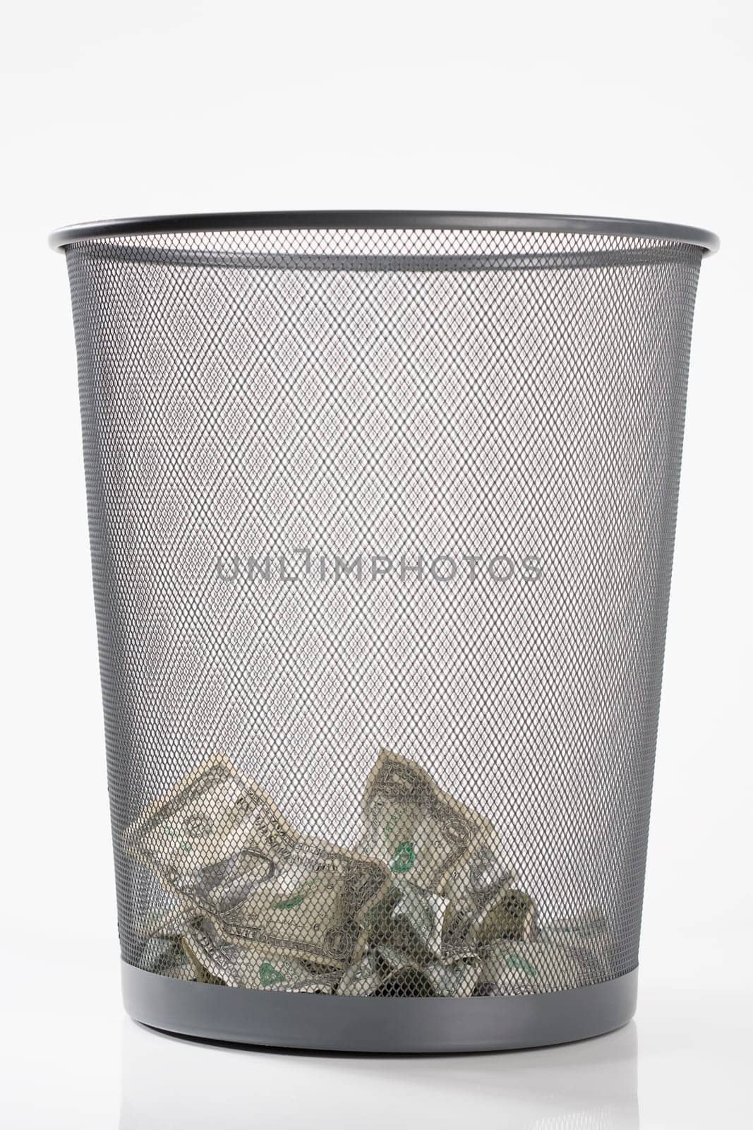 Close_up of US dollar bills in a garbage bin