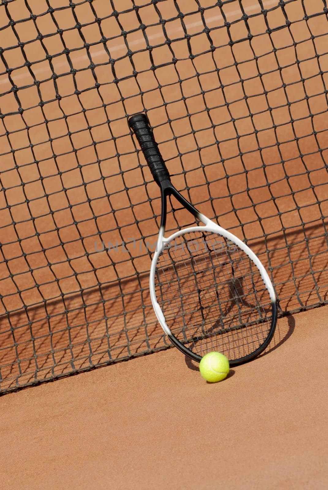 Tennis racket a tennis ball against a tennis net