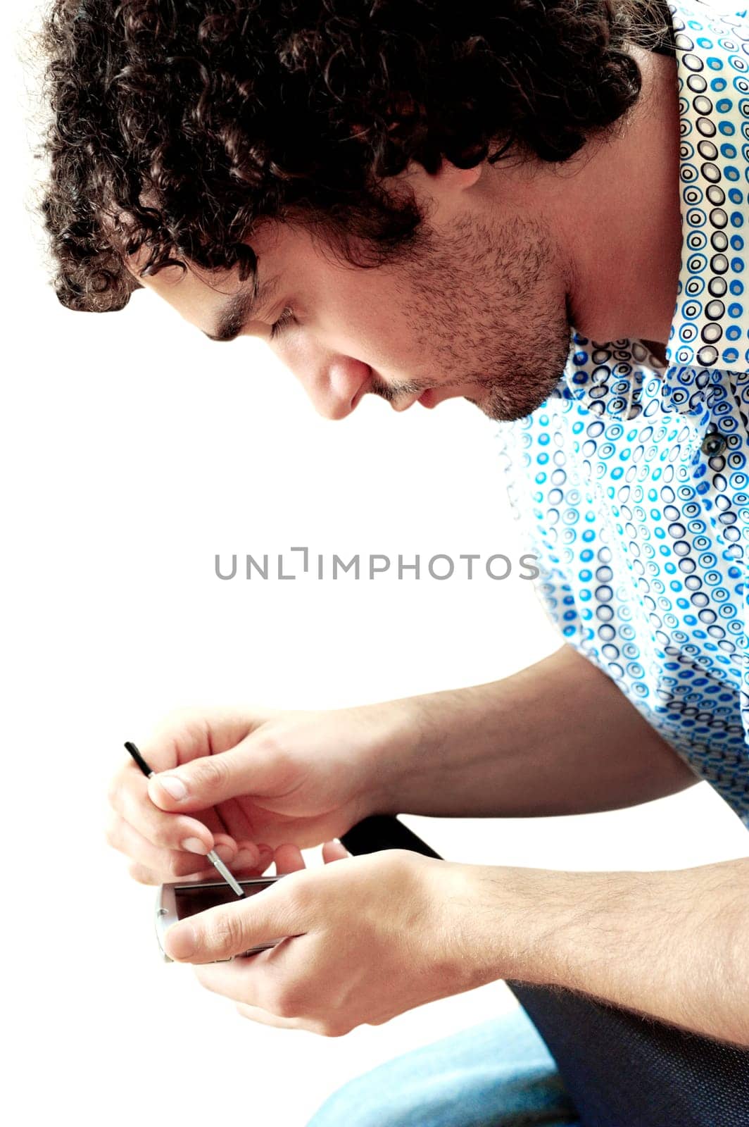 Side profile of a young man operating a personal data assistant