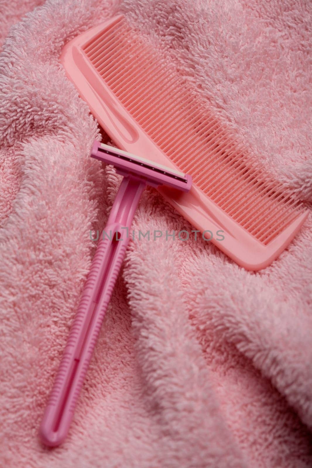 High angle view of a razor and a comb on a towel
