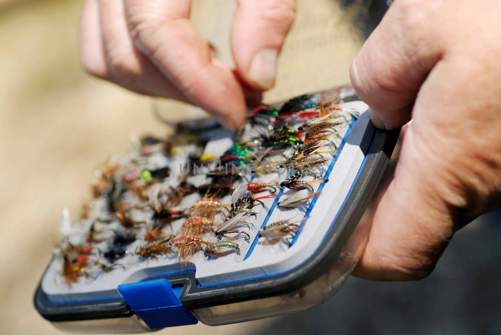 Close-up of a personŽs hand holding a fly box