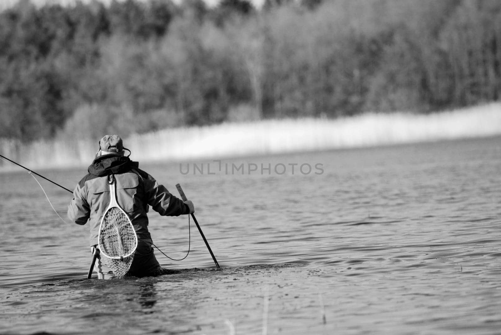 Rear view of a man fishing in the river