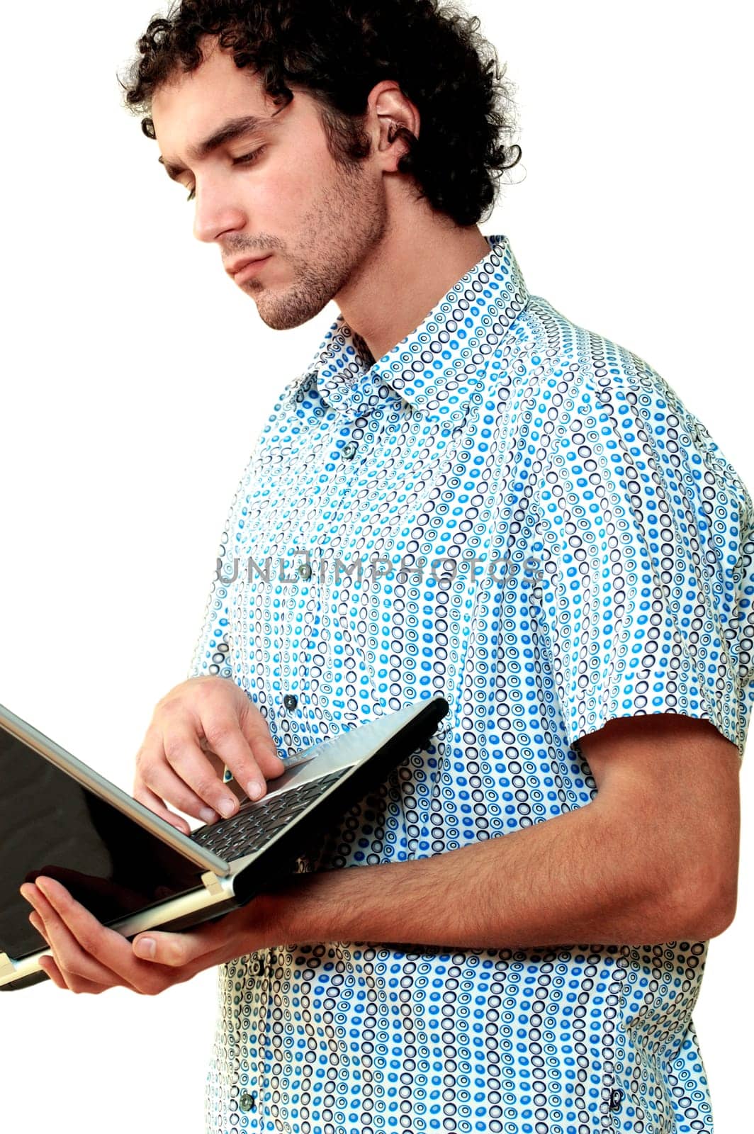 Side profile of a young man using a laptop