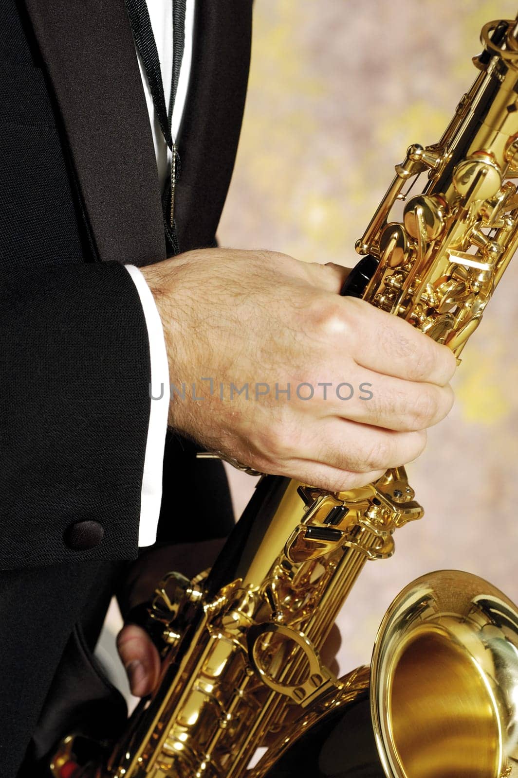 Mid section view of a musician playing the saxophone