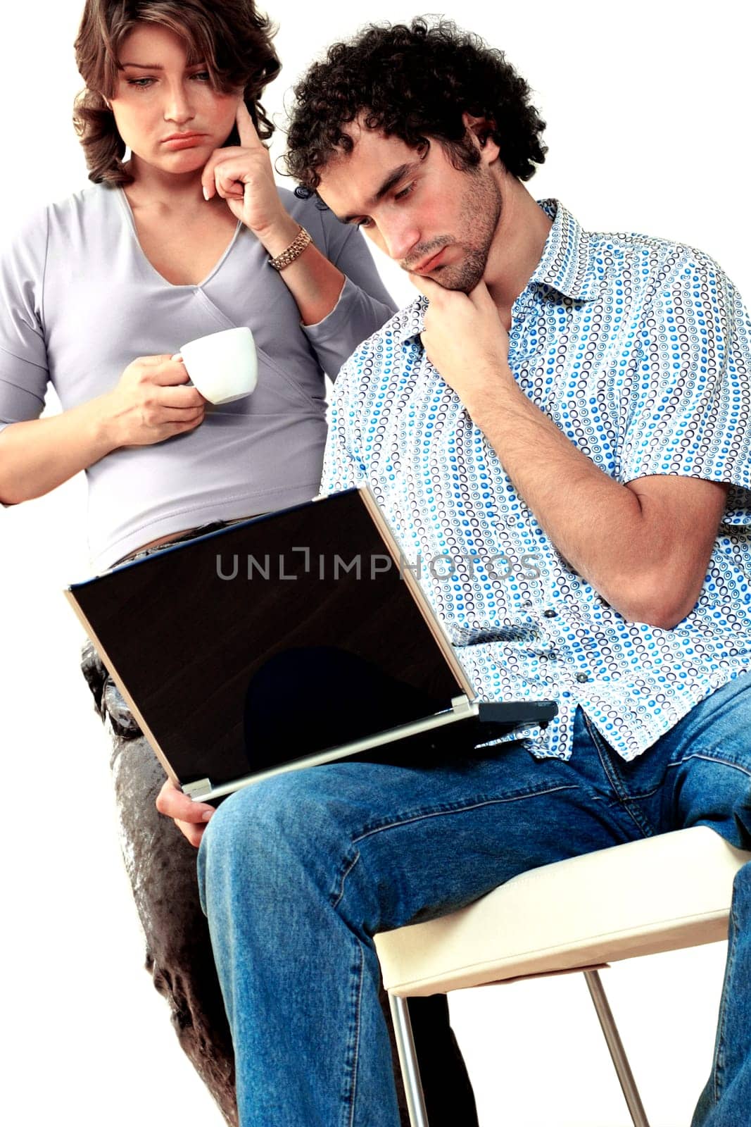 Young couple thinking while working on a laptop
