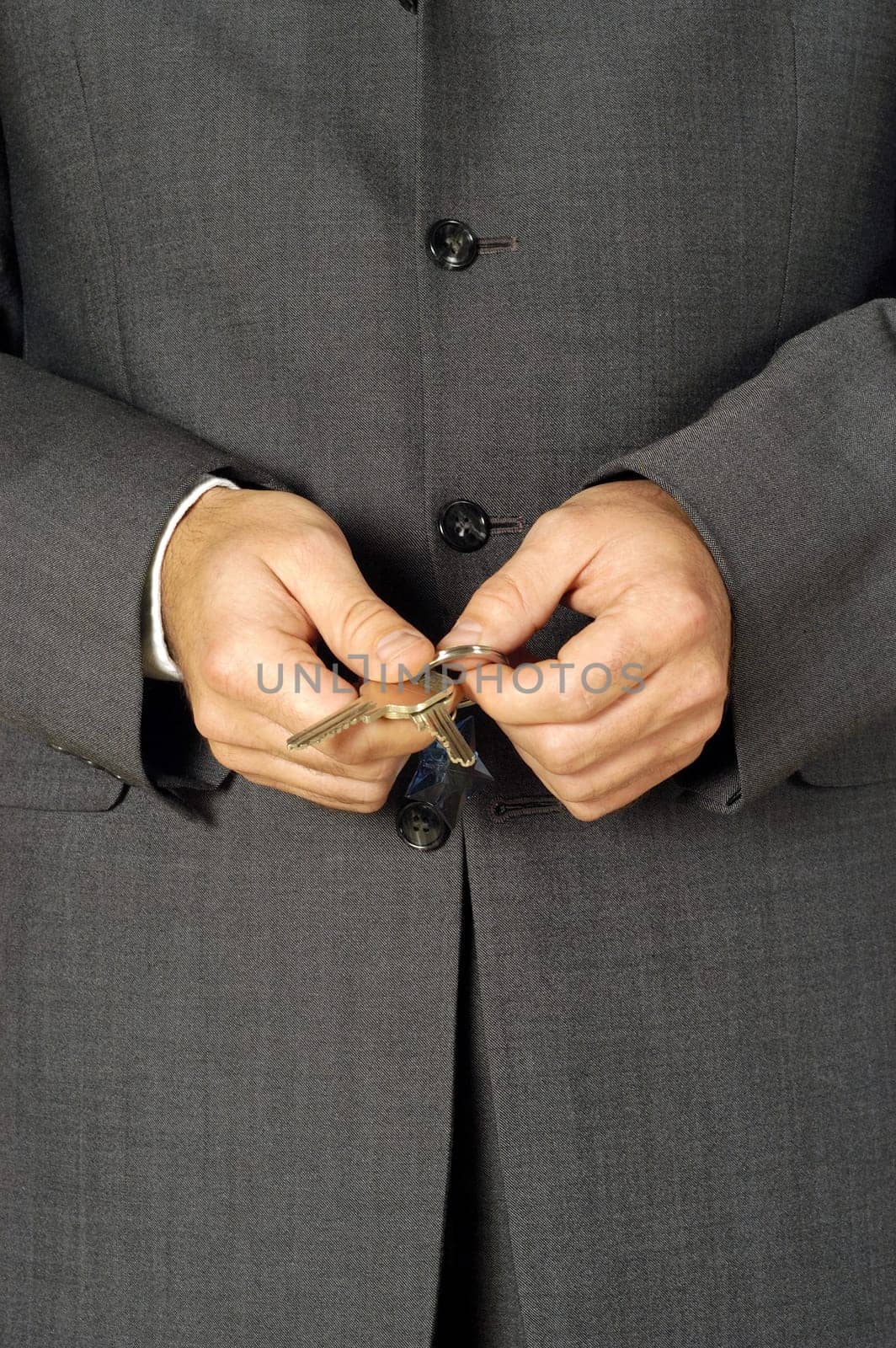 Mid section view of a businessman holding keys