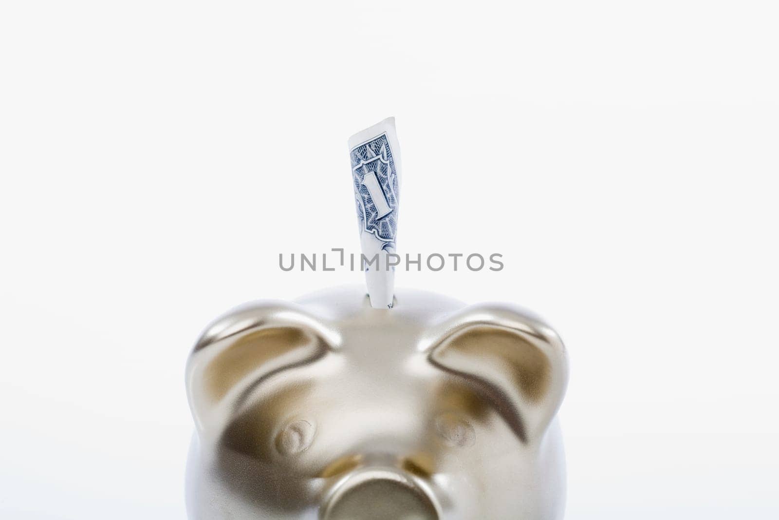 Paper currency sticking out of a piggy bank