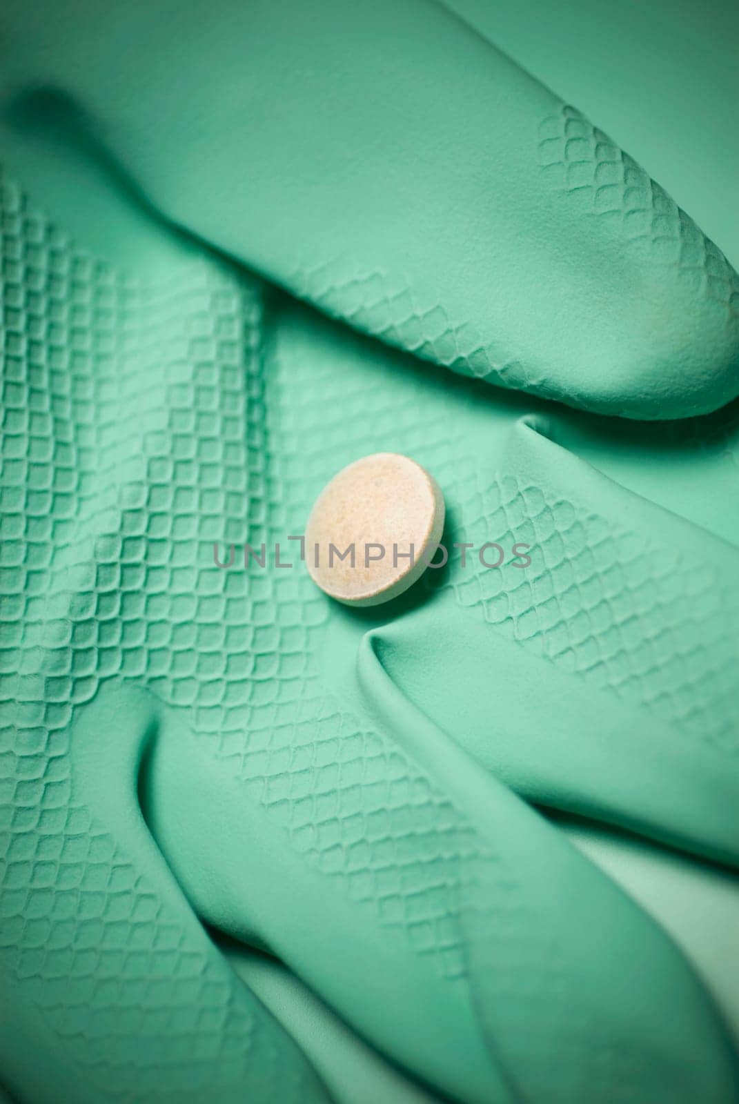 Close_up of a pill on a glove