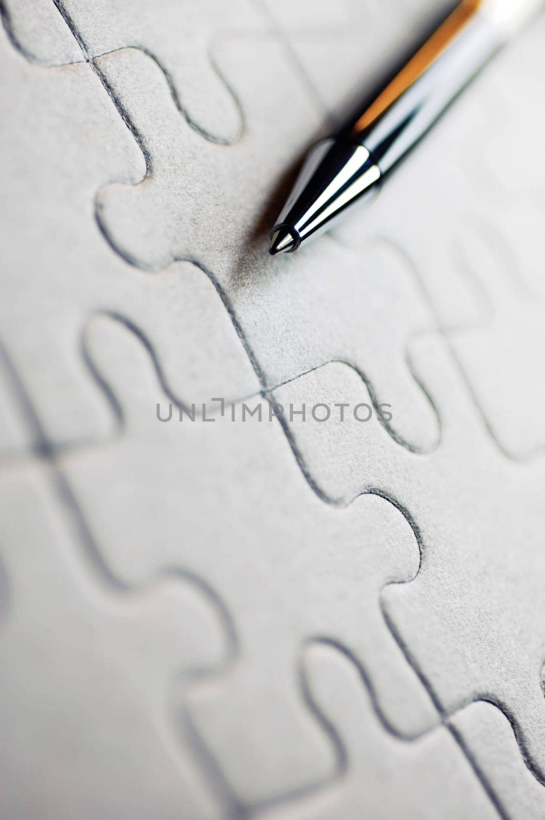 Close-up of a pen on a jigsaw puzzle