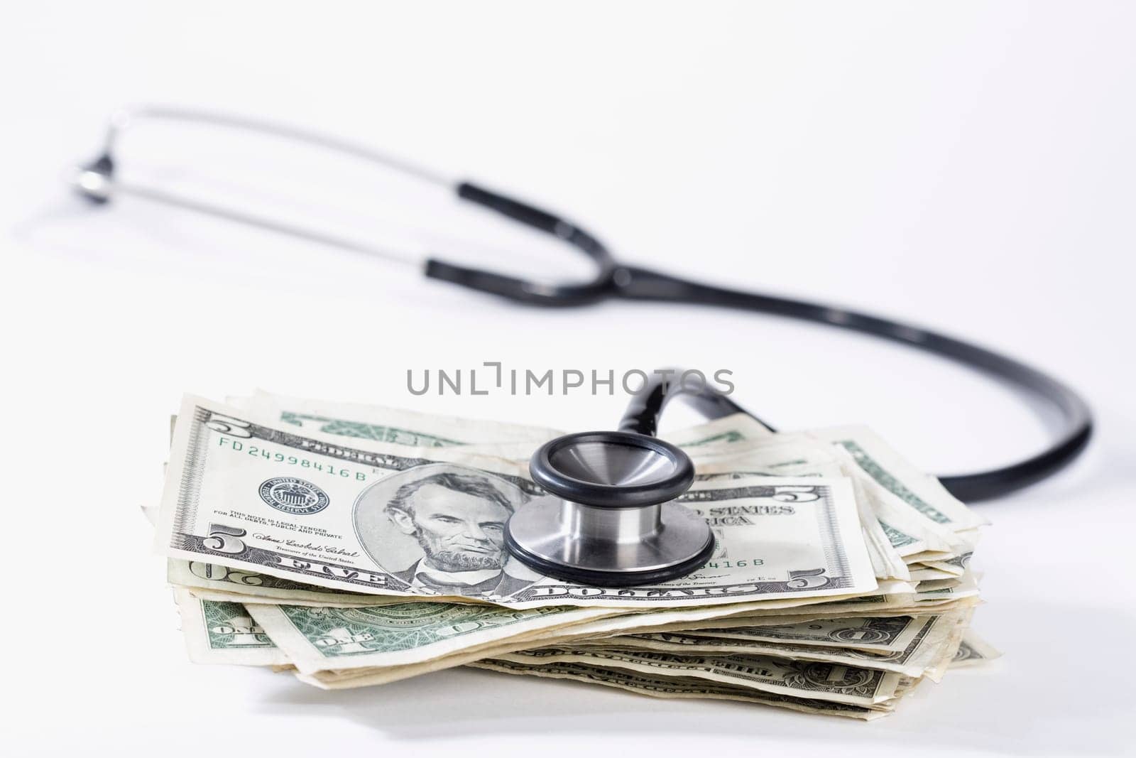 Close_up of stethoscope on US dollar bills