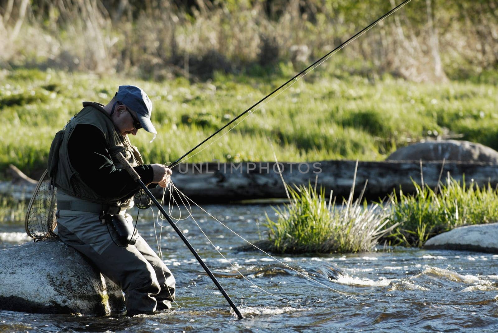 Side profile of a mature man fishing in the river