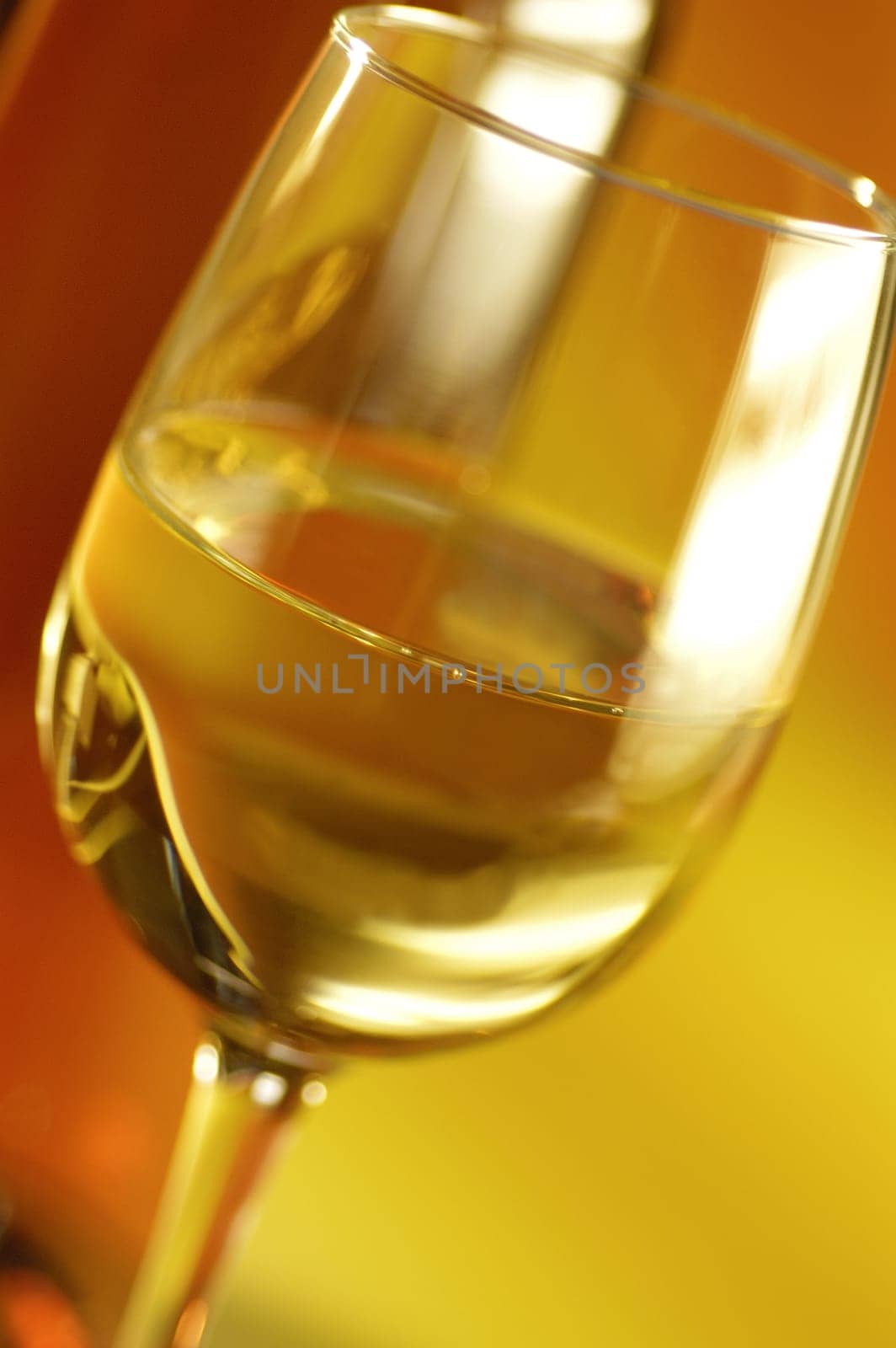 Close-up of a glass of wine with a wine bottle