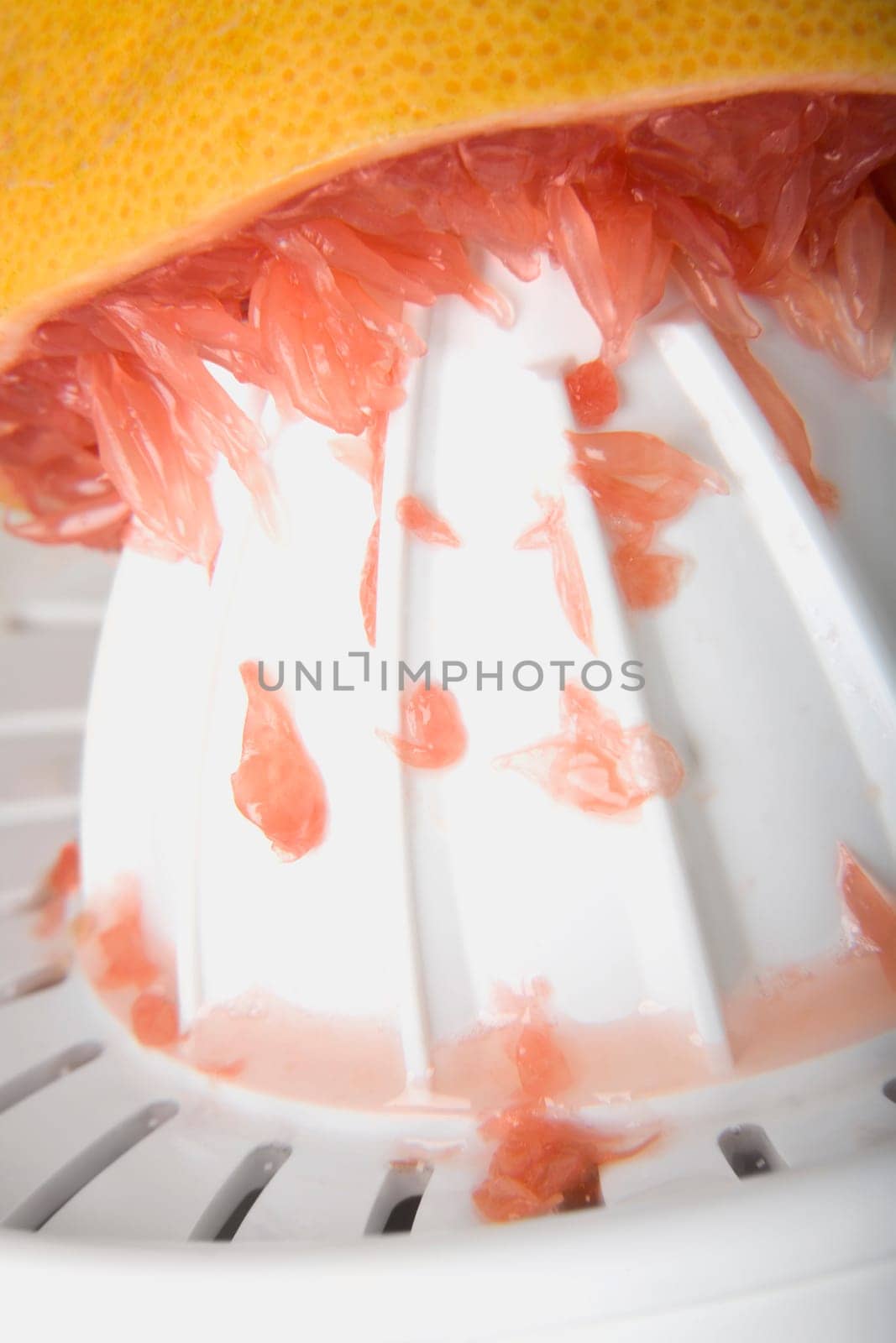 Close-up of a Tangerine squeezed on a juice squeezer