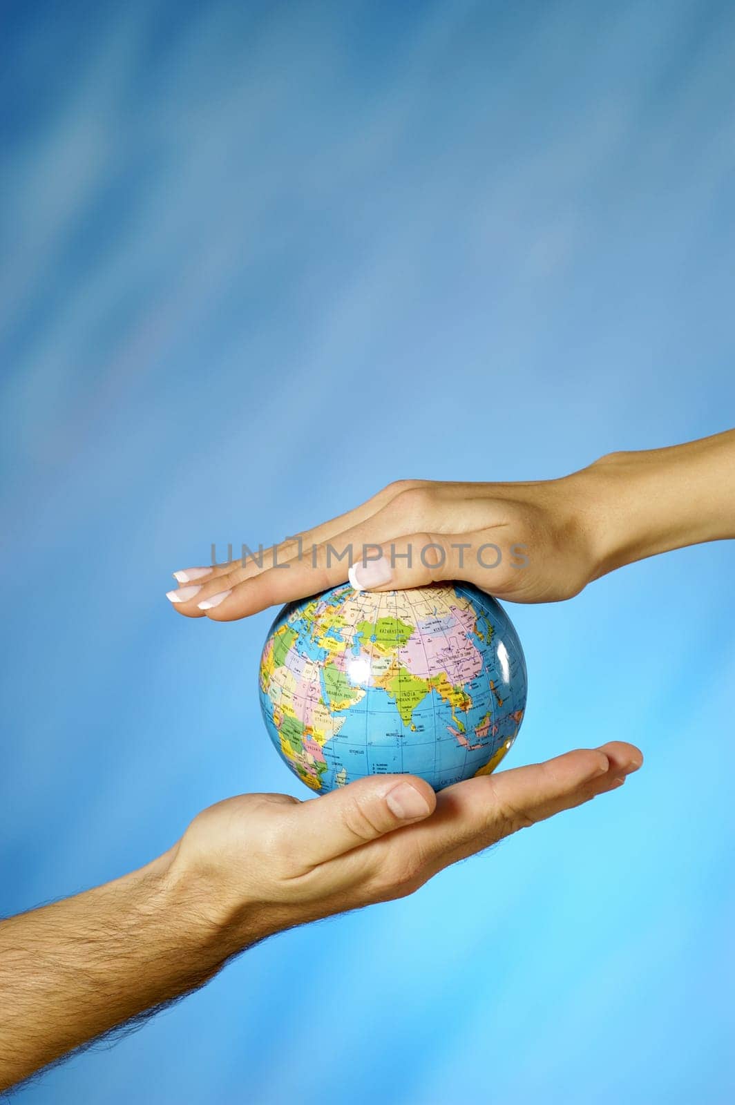 Close-up of a man and a womanŽs hands holding a globe