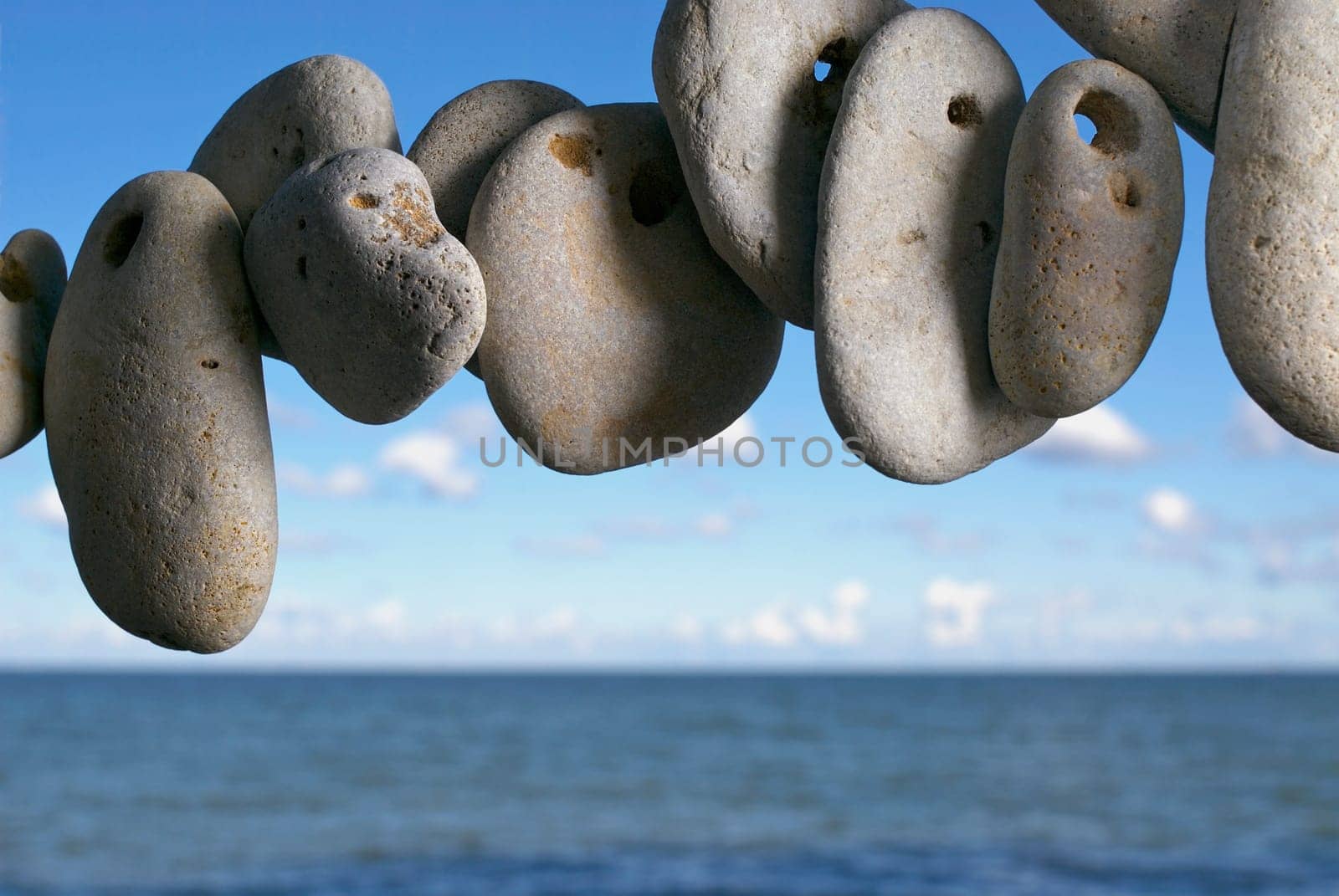 Pebbles in air with sea in the background