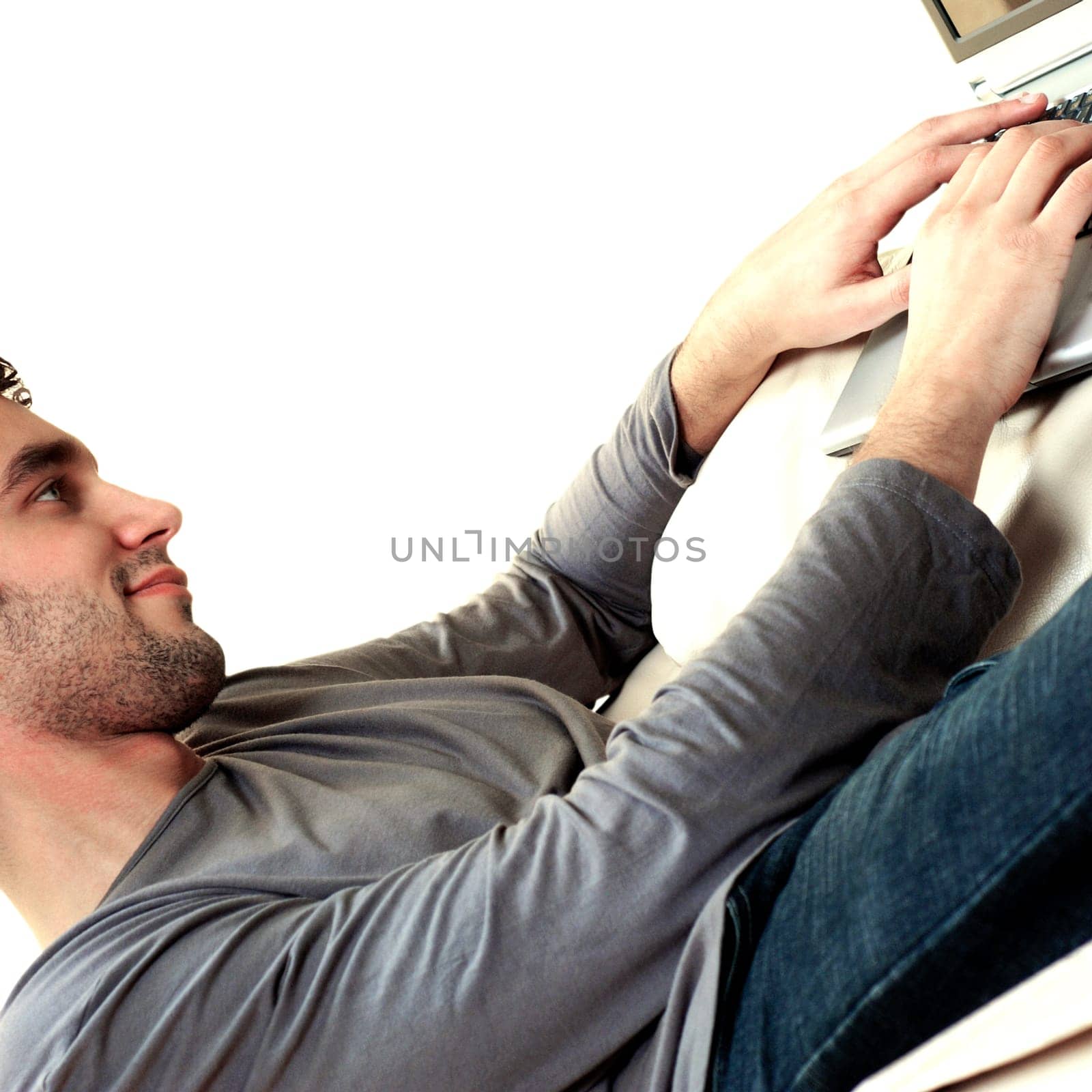 Side profile of a young man using a laptop