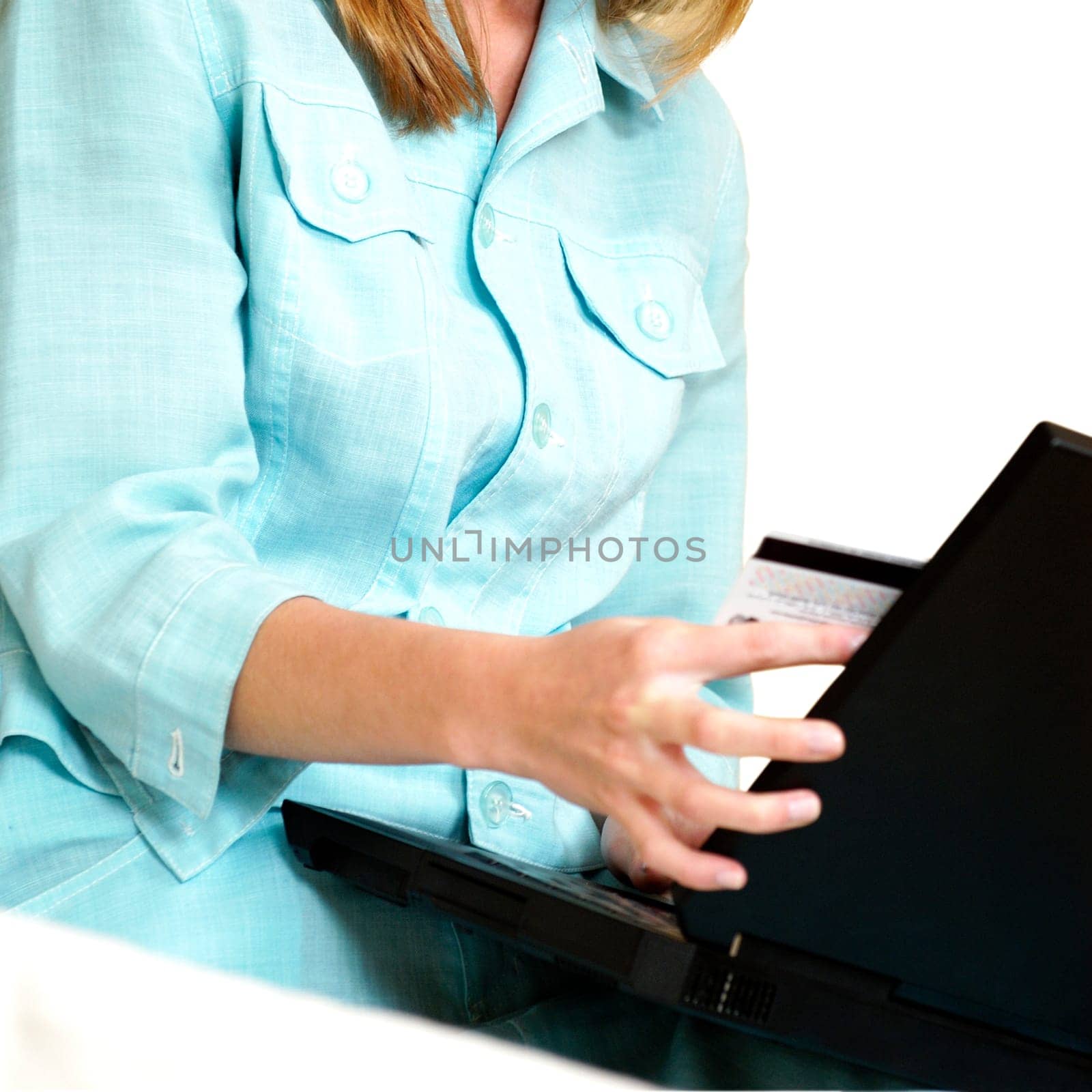 Mid section view of a businesswoman using a laptop
