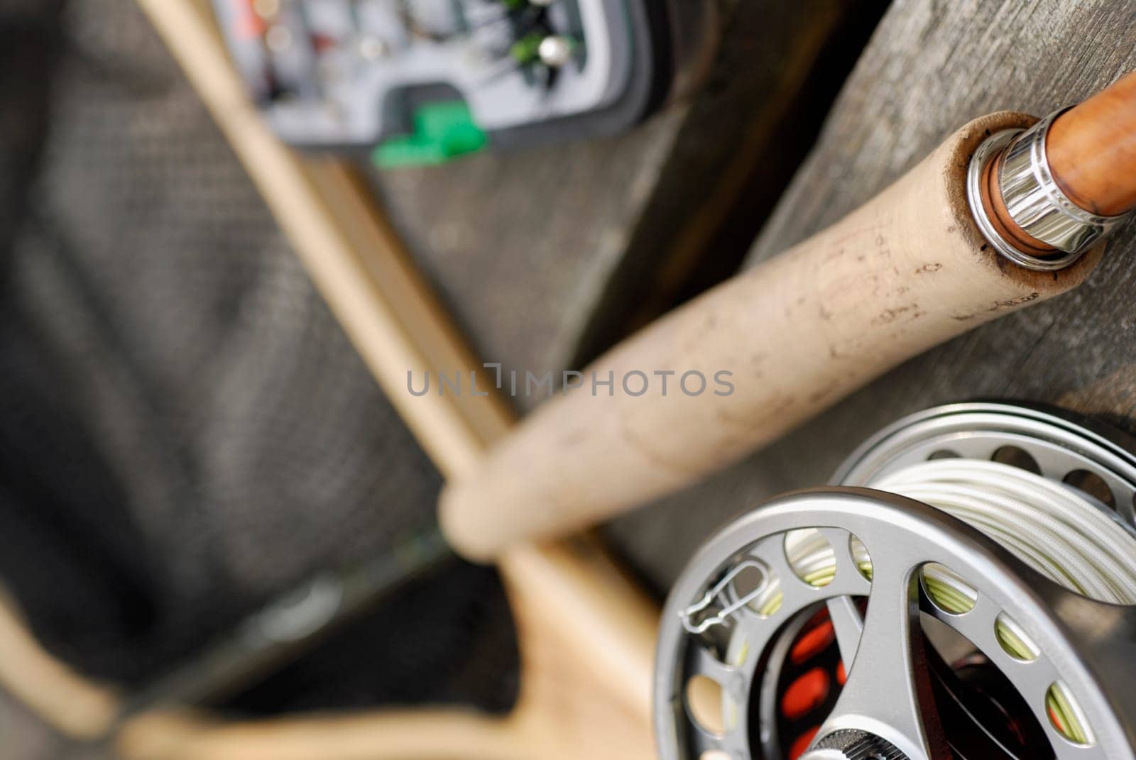 Close-up of a fishing reel and a fishing rod