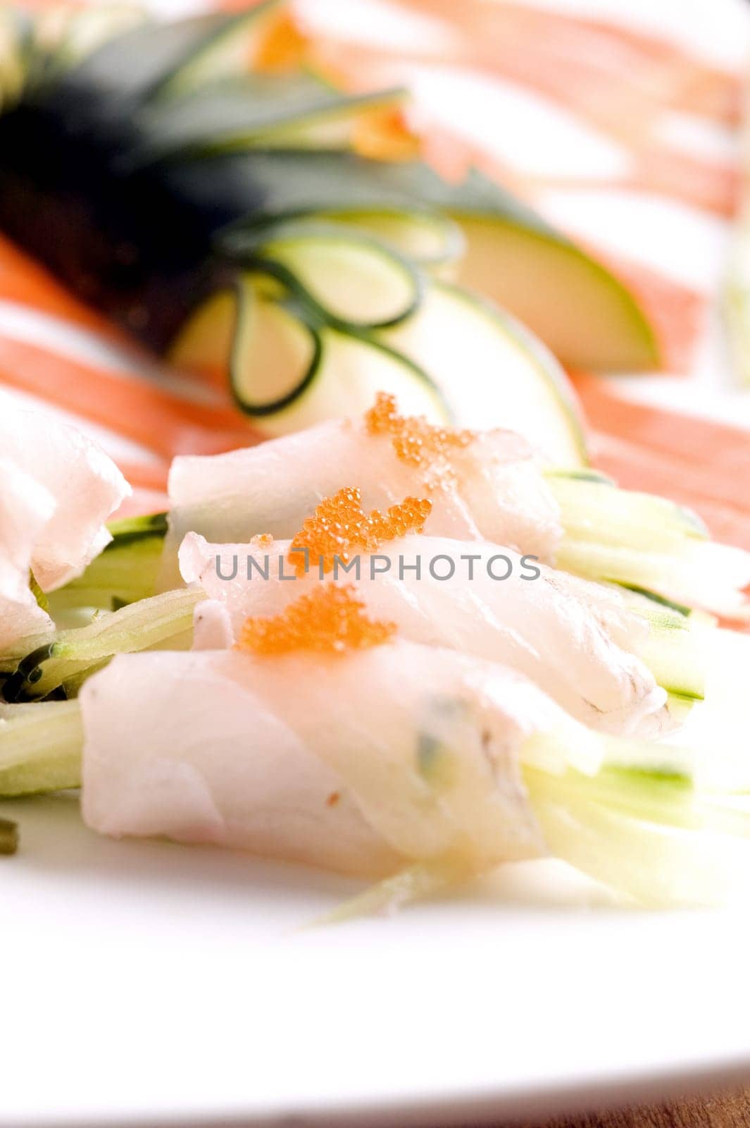 Close-up of prepared fishes topped with caviar in a plate
