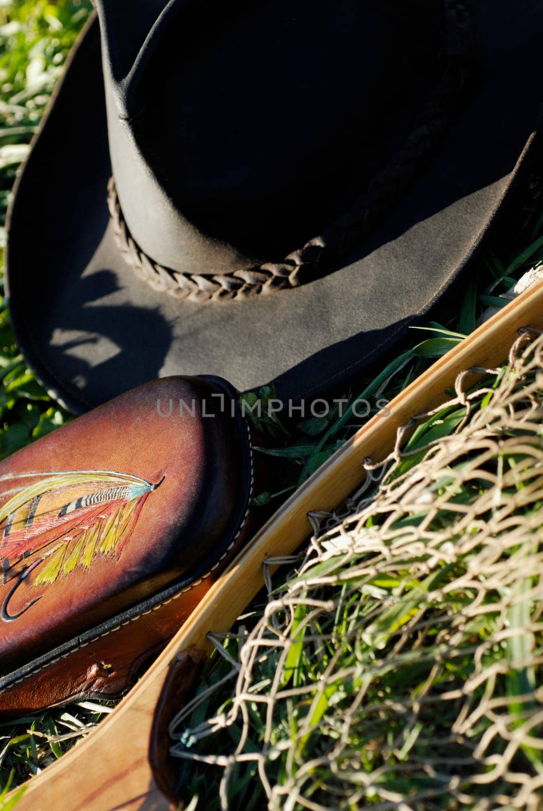 High angle view of a fishing net and a cowboy hat on the lawn