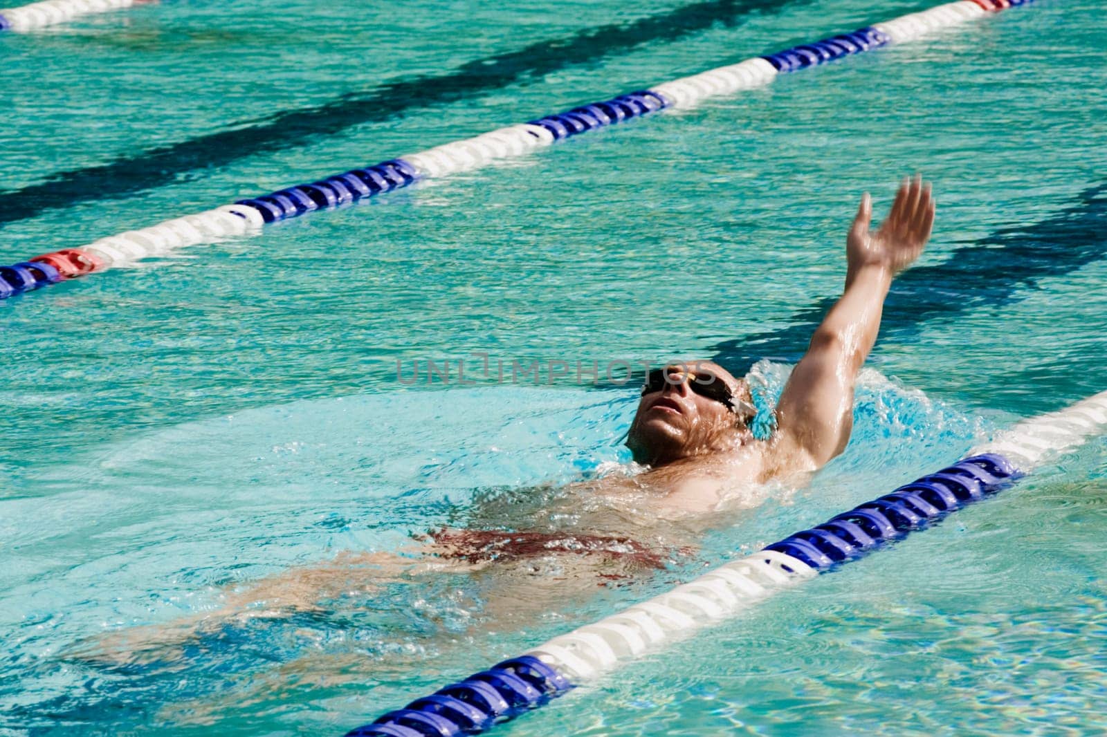 Mid adult man swimming in a swimming pool