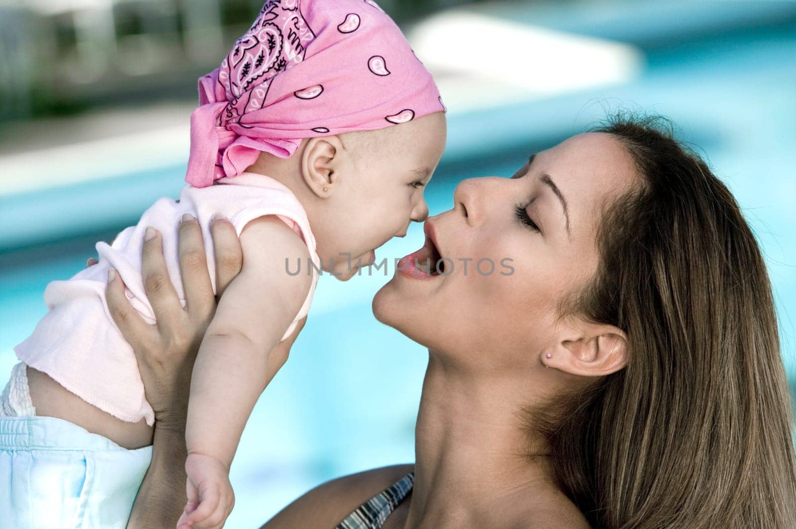 Close-up of a young woman picking up her daughter