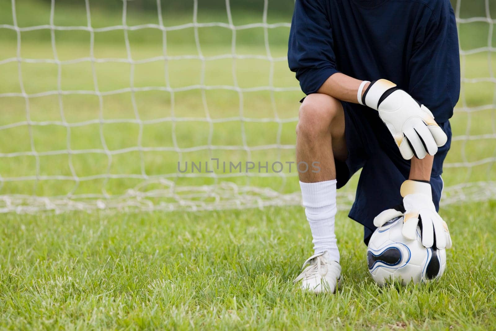 Close-up of a goalie touching a soccer ball