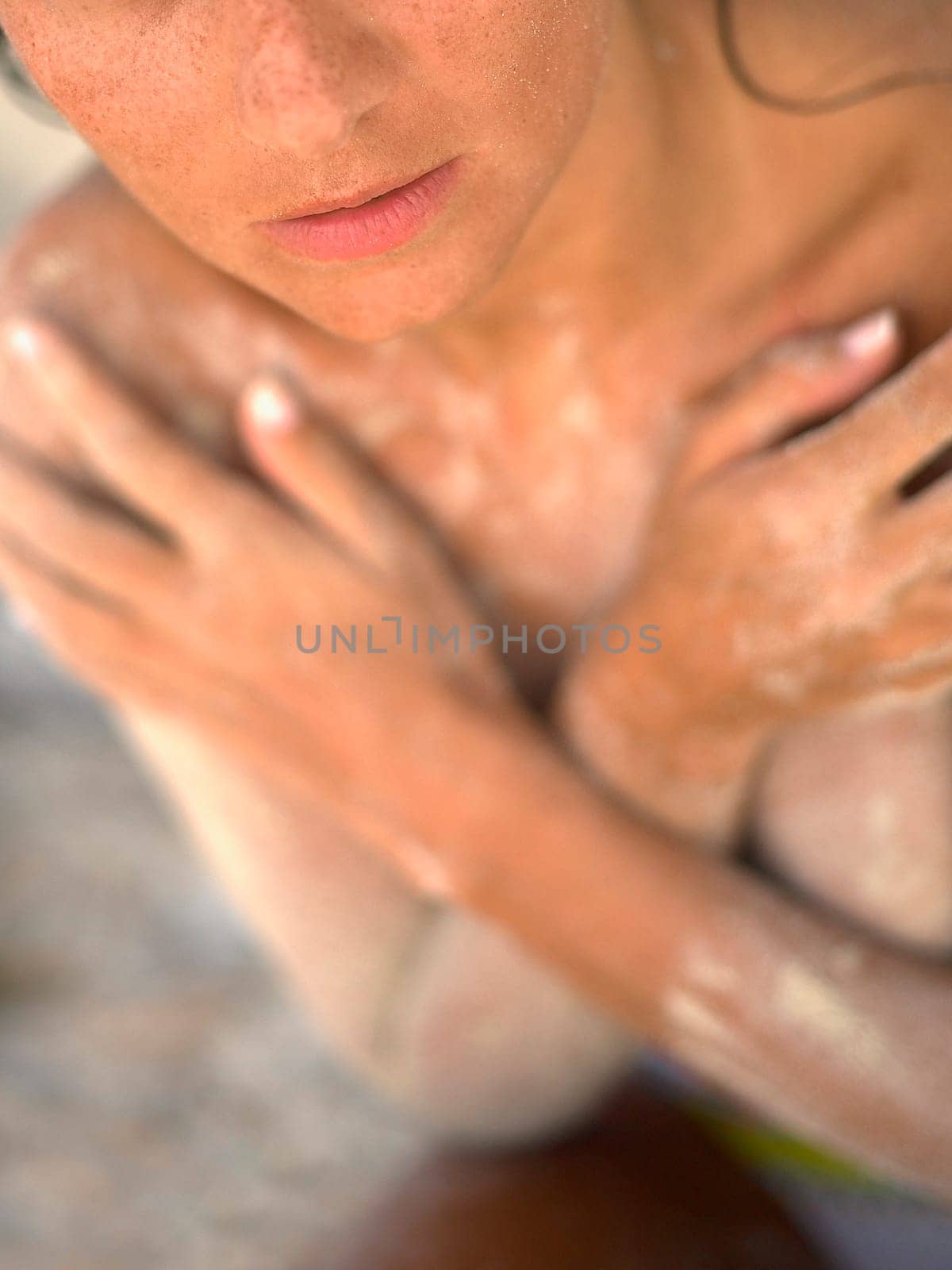 Mid section view of a young woman covering her breast