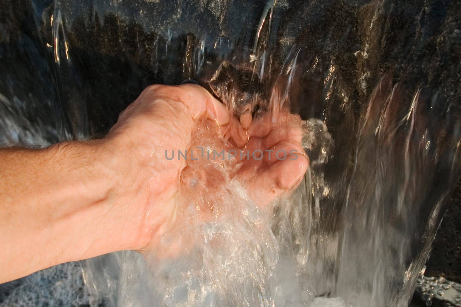 Close-up of a personŽs hand touching water