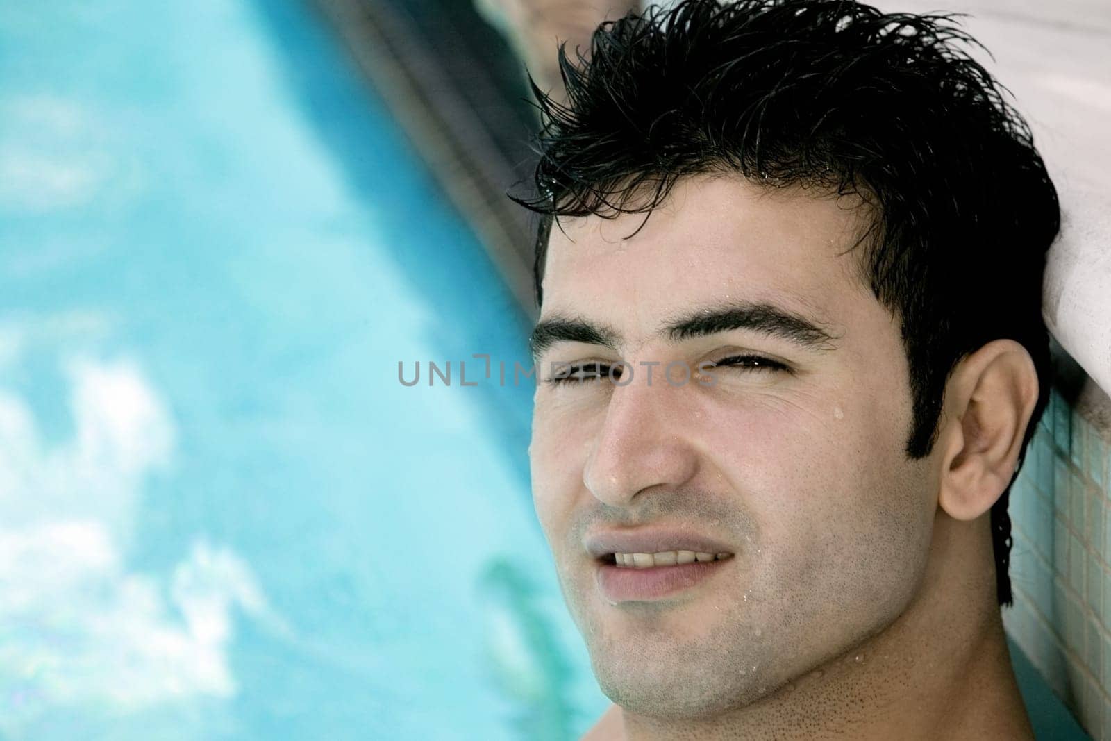 Portrait of a young man in a swimming pool