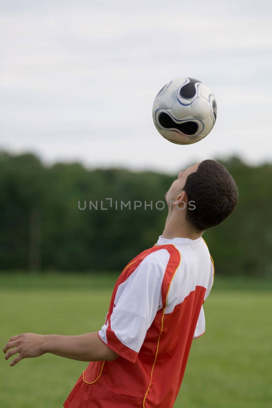 Side profile of a soccer player heading a ball