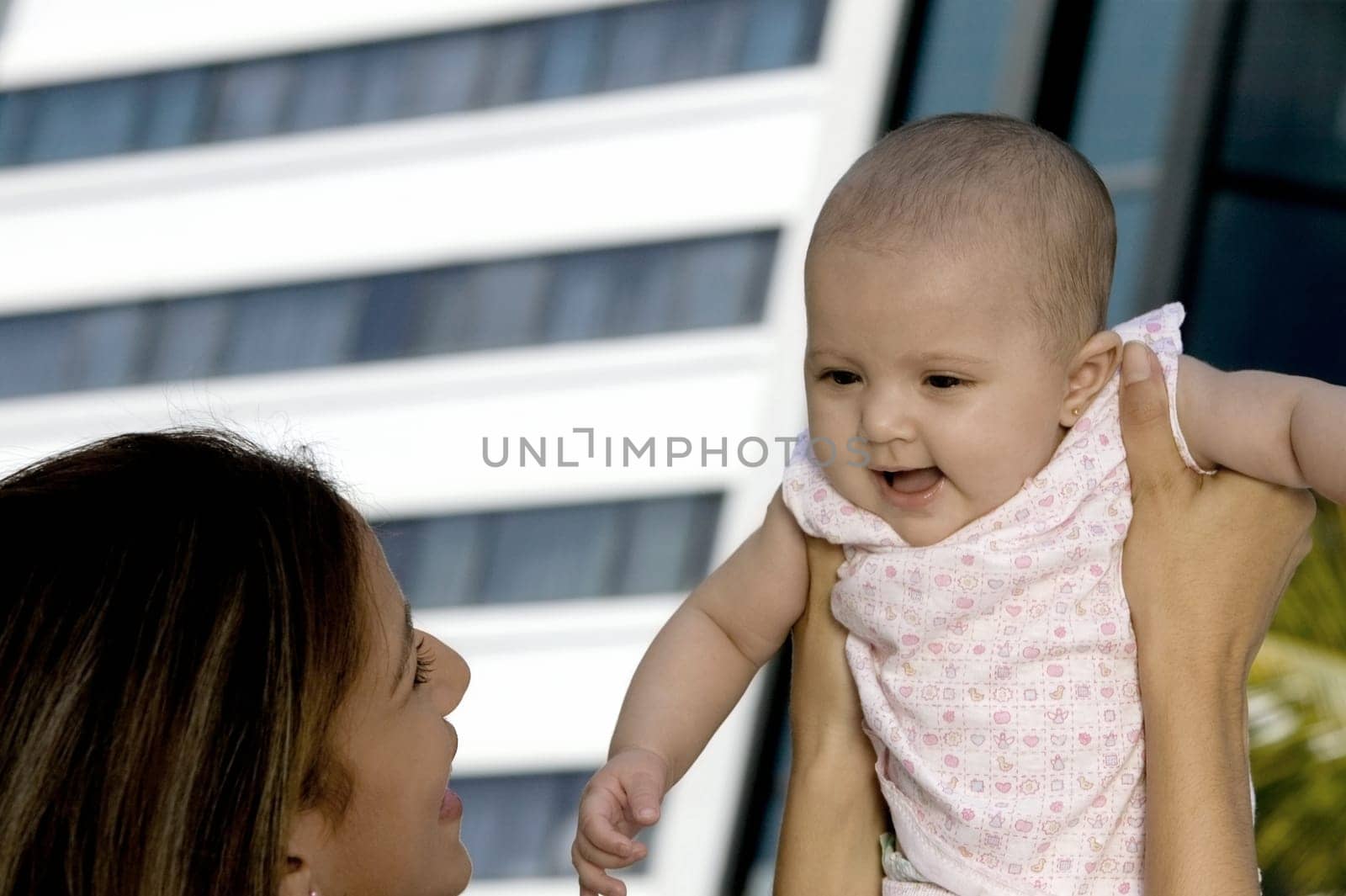 Mother holding up her daughter