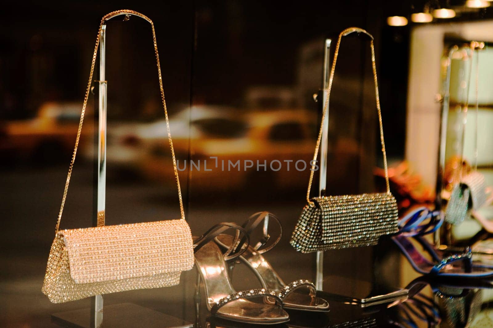 Close-up of two purse with a pair of sandals